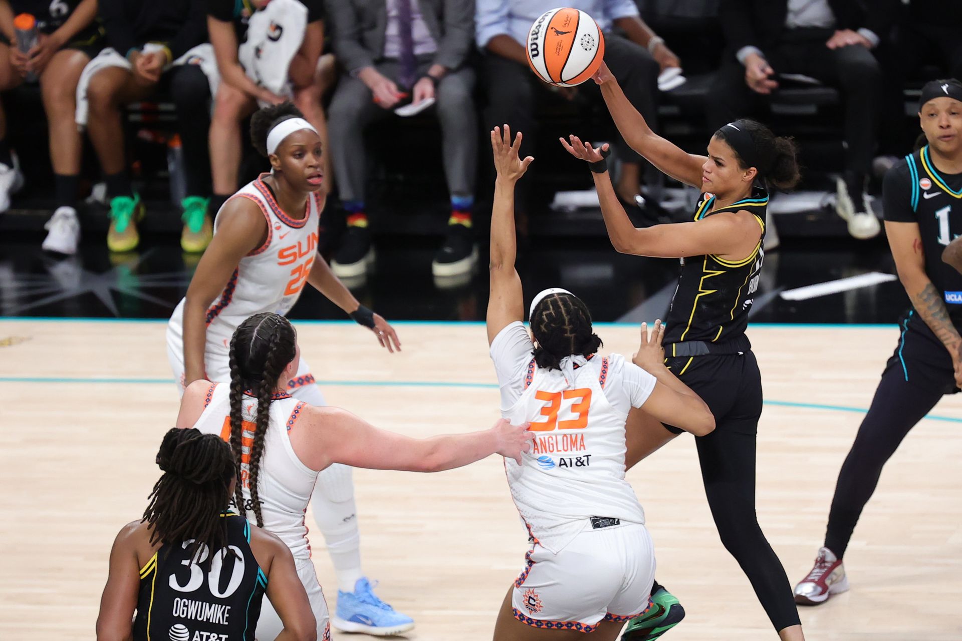 Rae Burrell passes under pressure in a WNBA game