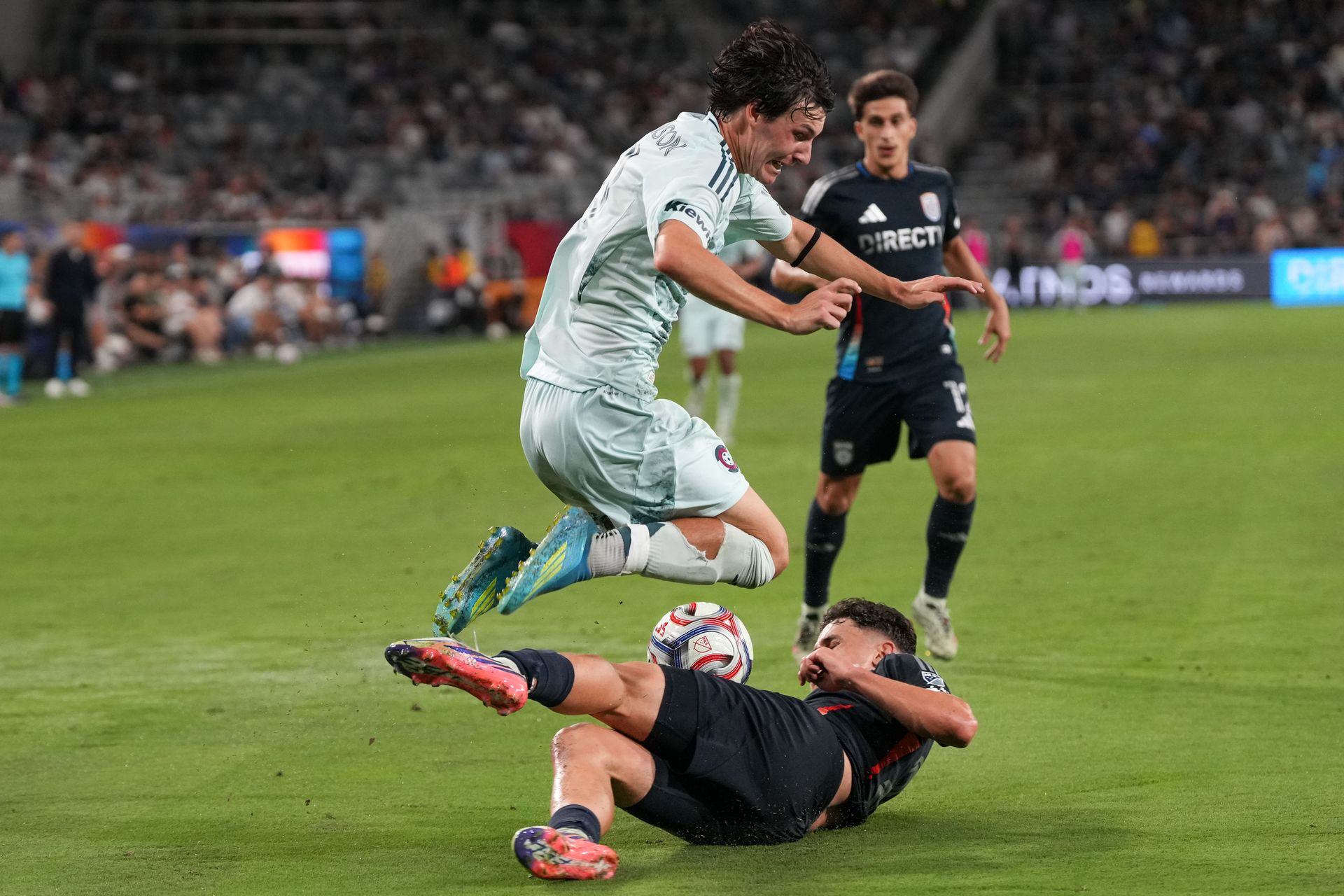 Luca Bombino makes a sliding tackle in MLS game