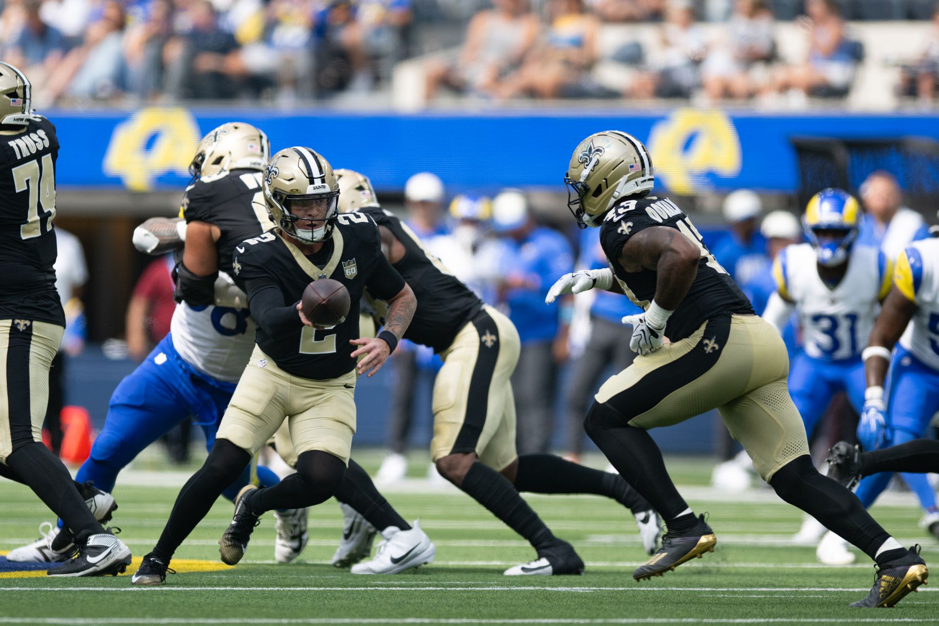 Saints QB Spencer Rattler hands off the ball in preseason game