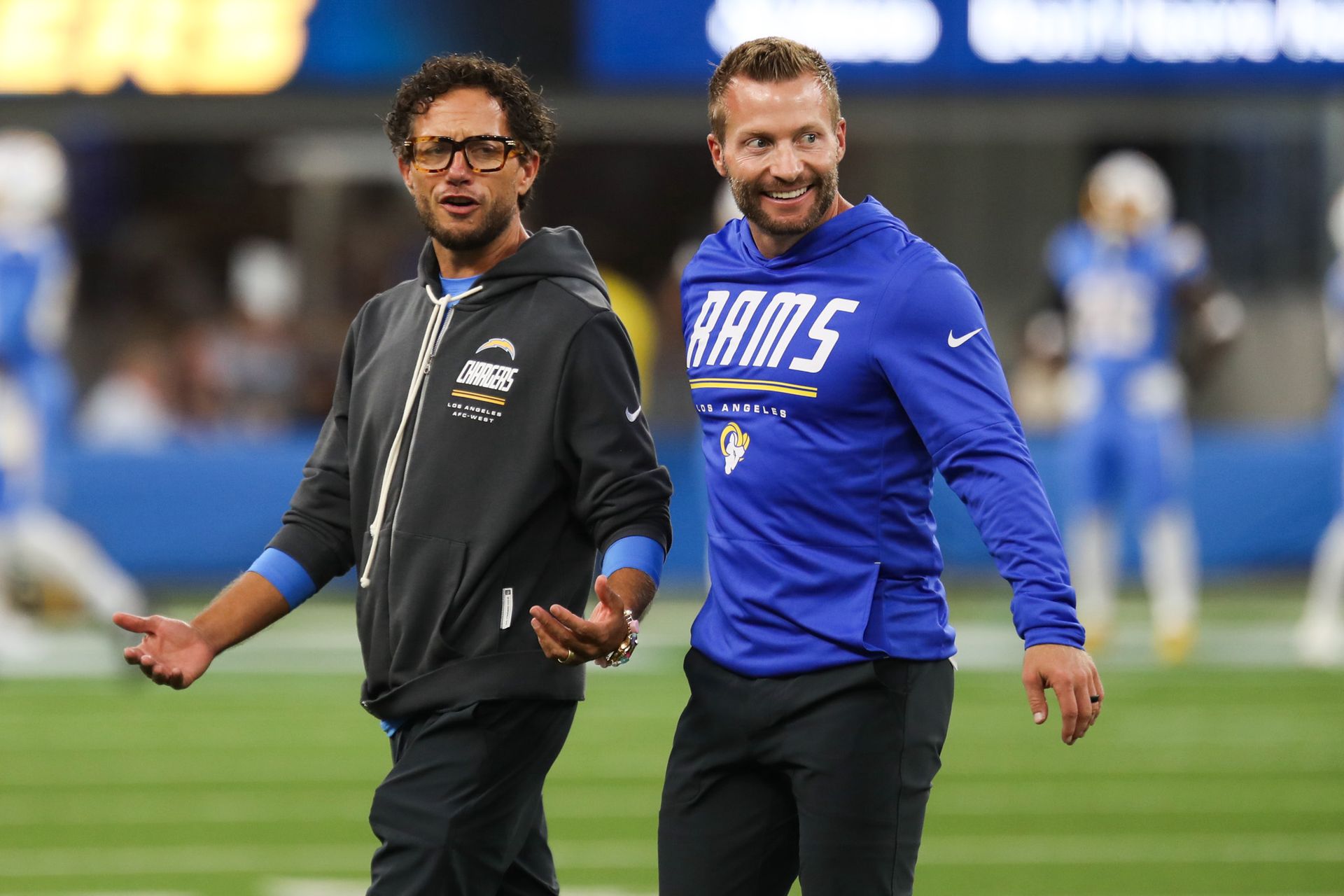 Sean McVay and Mike McDaniel discuss strategy before the game.