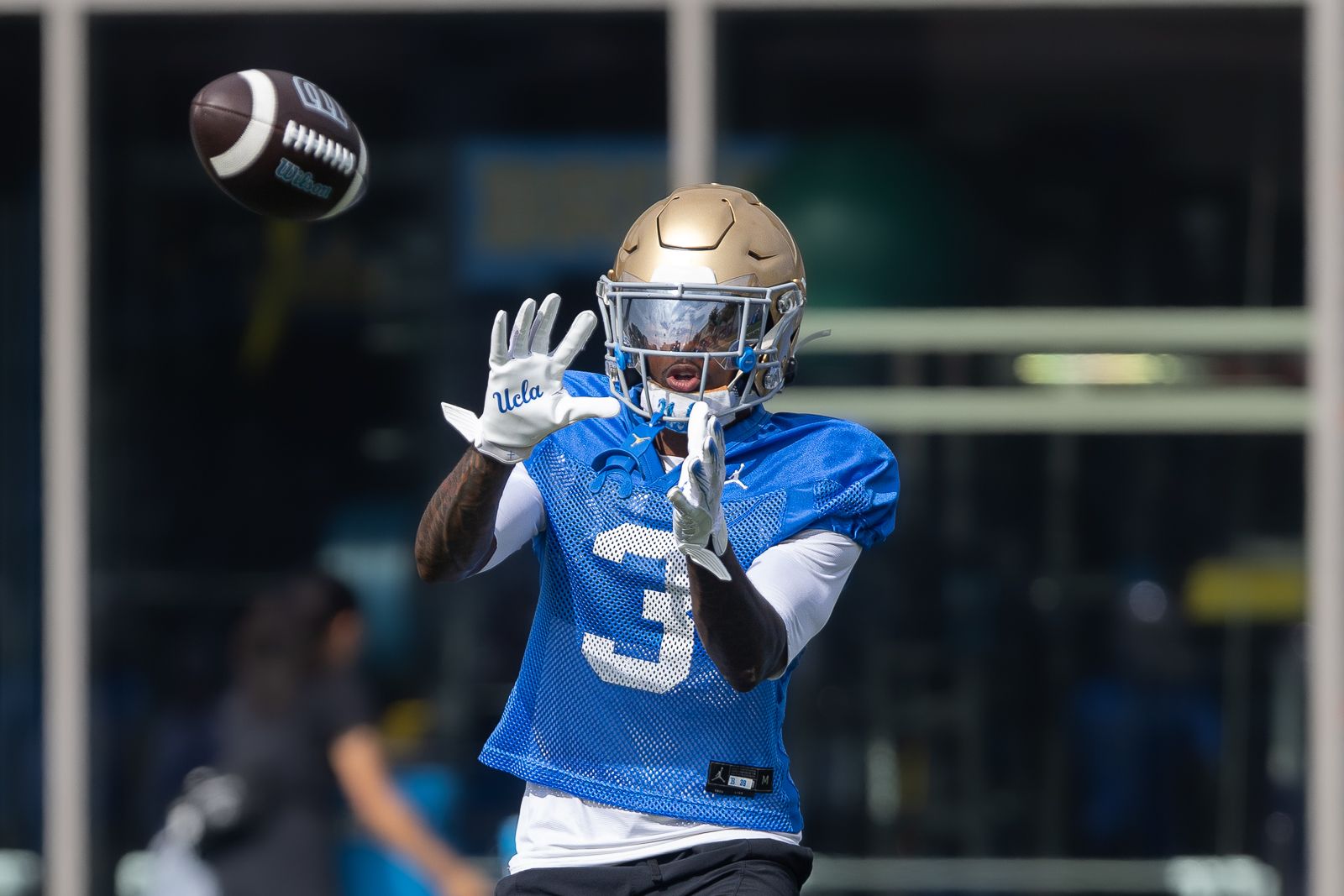 Robert Stafford III (3) catches a pass during UCLA practice