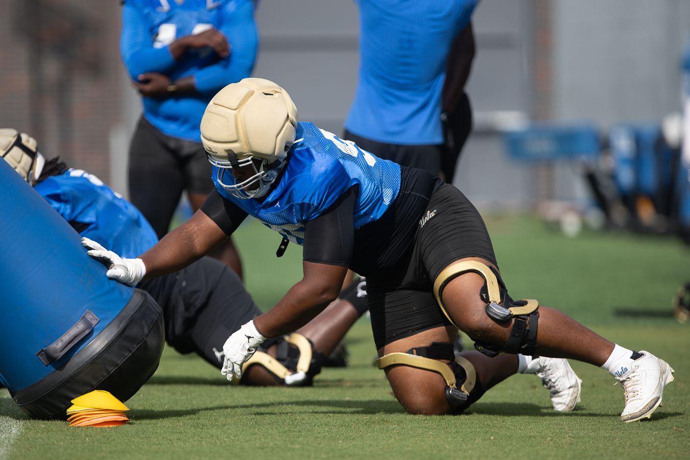 UCLA linemen engage with pads at practice