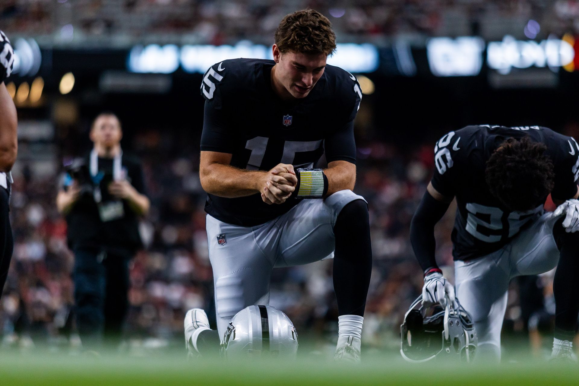 Fernando Mendoza prays before the Raiders vs. 49ers game