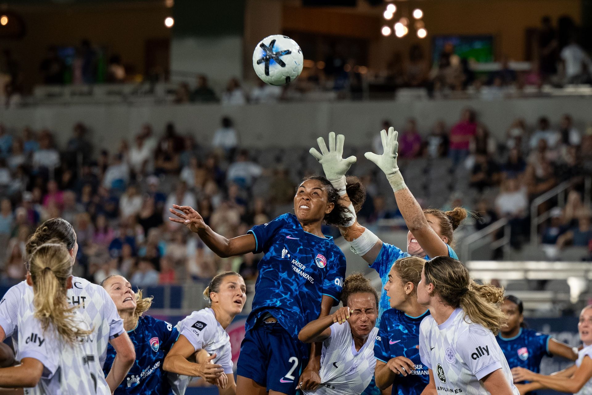 Kennedy Wesley attempts a header in NWSL game against Racing Louisville