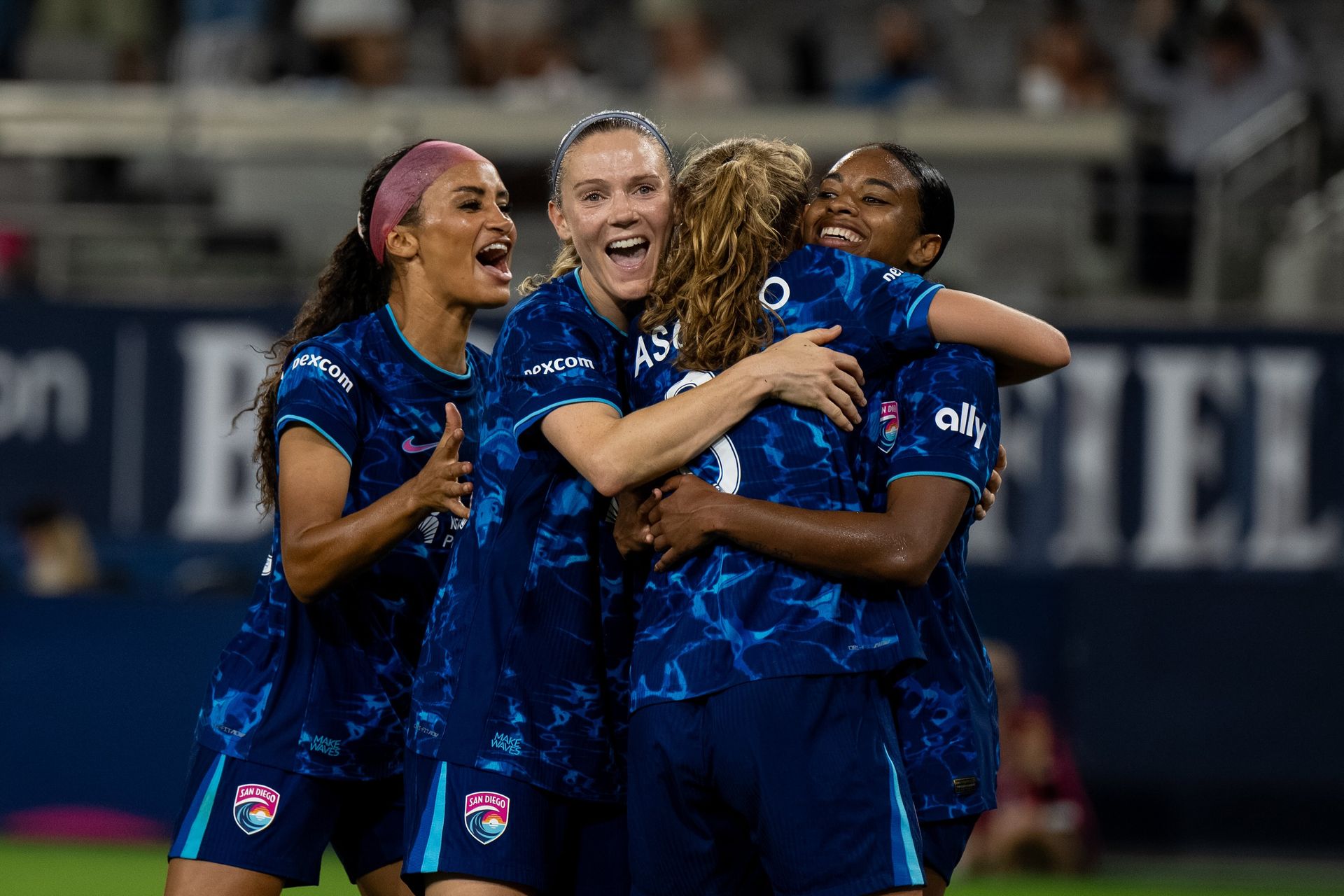 Trinity Byars celebrates a goal with teammates in NWSL match