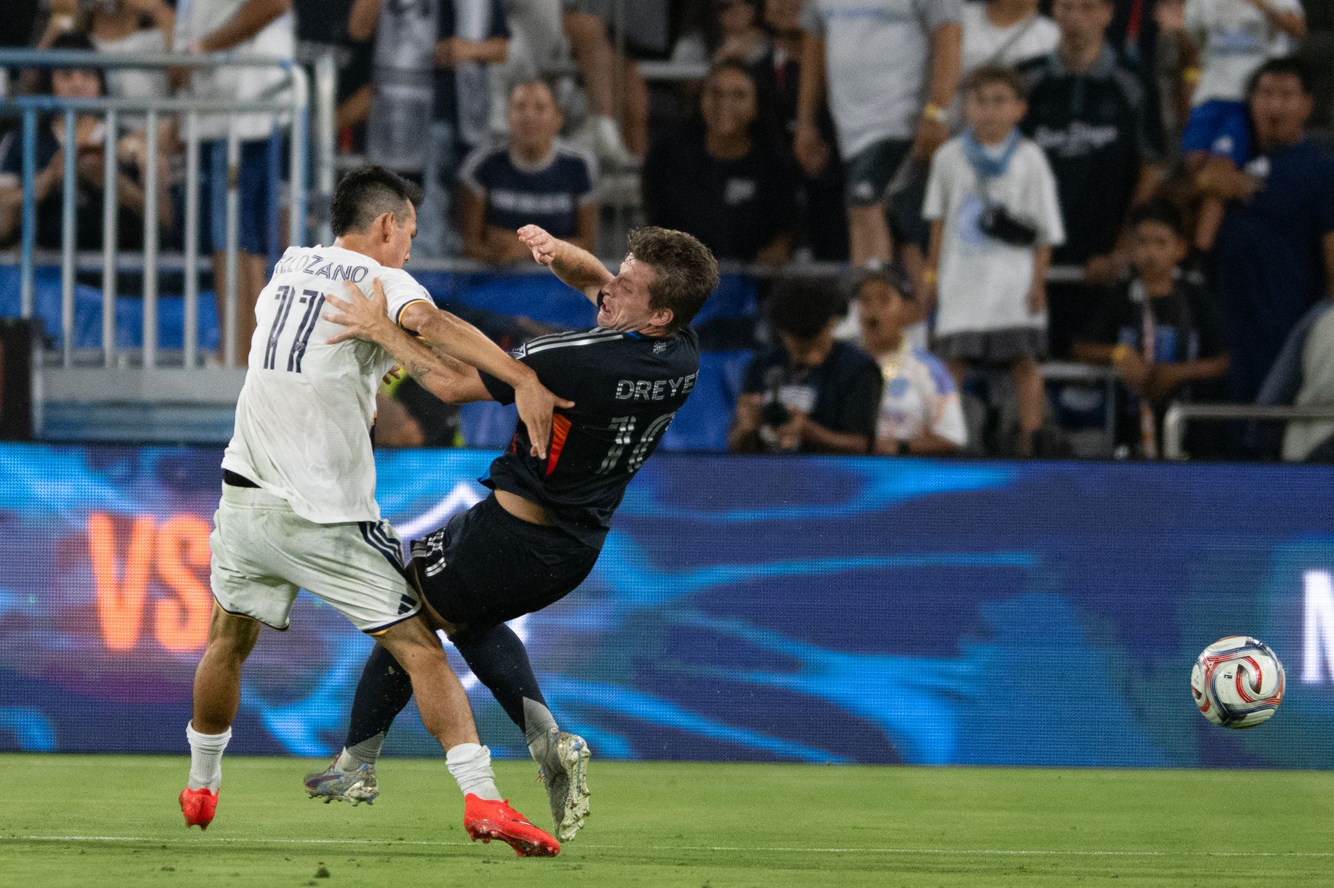 Hirving Lozano tackles Anders Dreyer in a tense MLS match moment