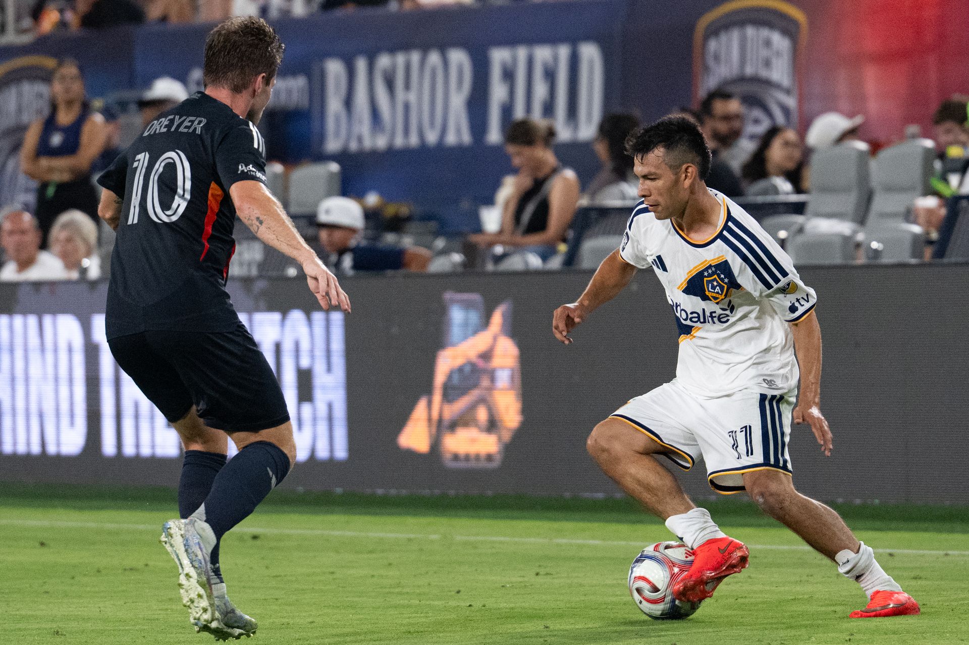 Hirving Lozano confronts Anders Dreyer during the MLS game