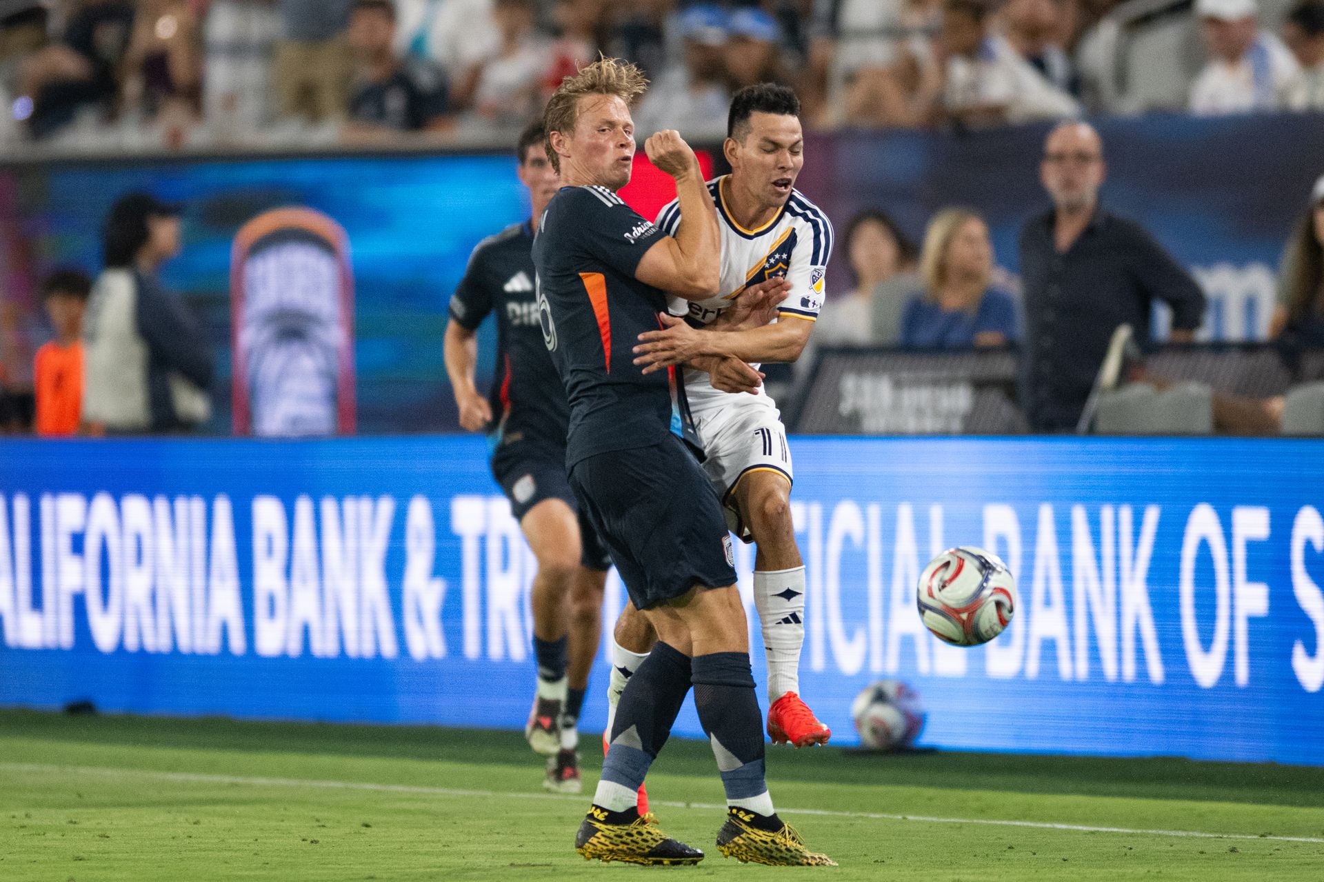 Hirving Lozano endures a tough tackle in the match