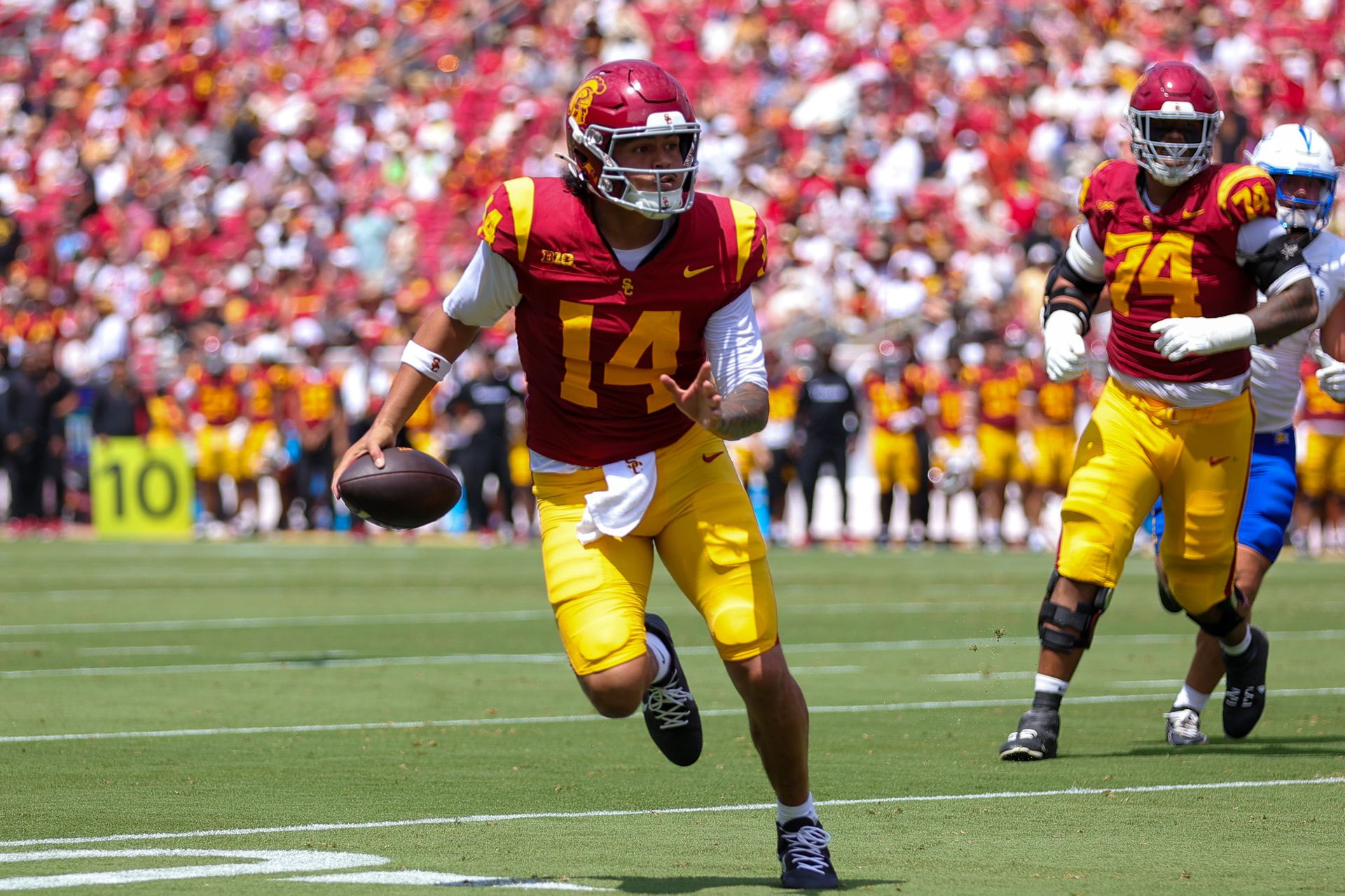 Jayden Maiava (14) runs with the ball for USC against San Jose State