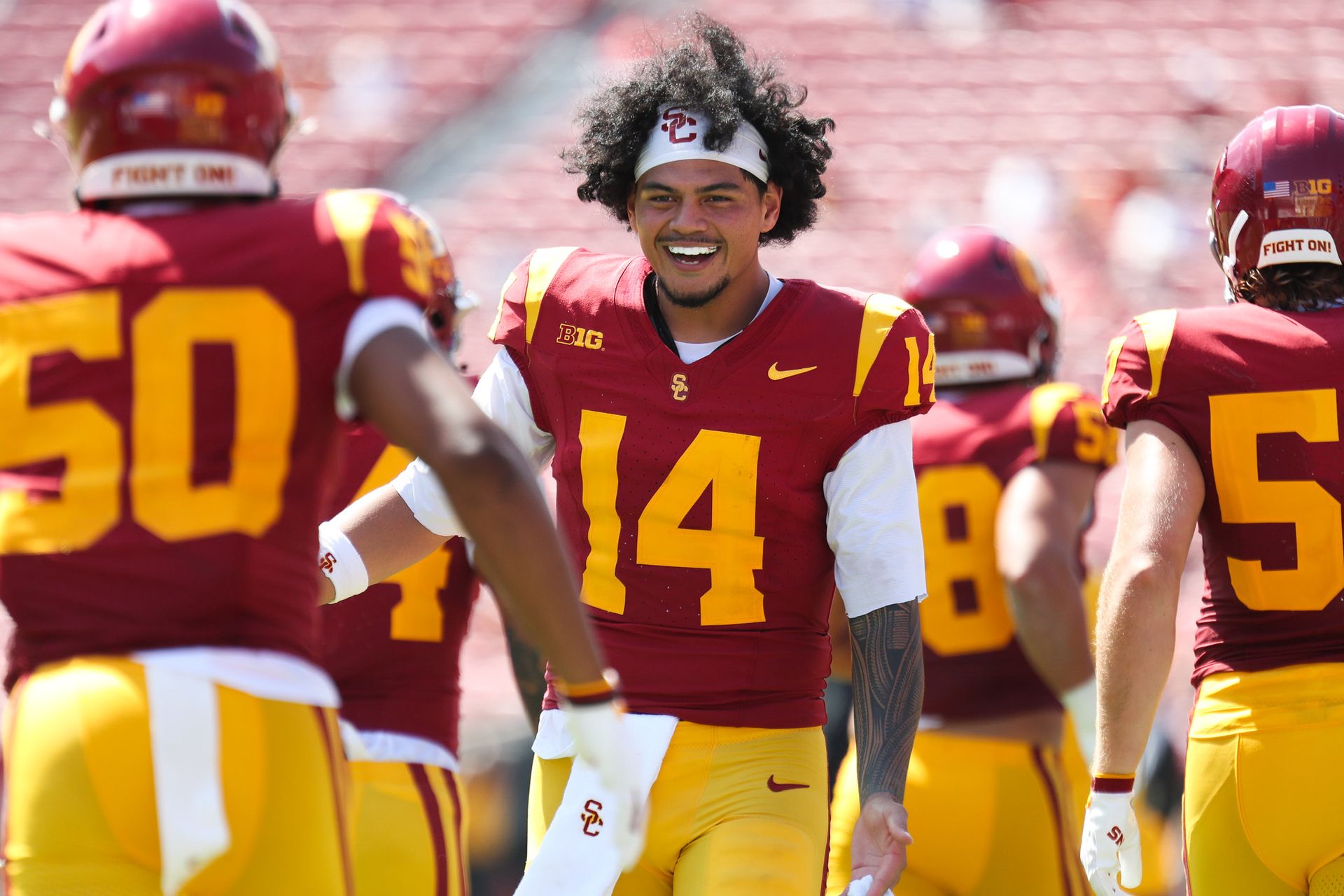 Jayden Maiava (14) cheers with teammates on the sidelines