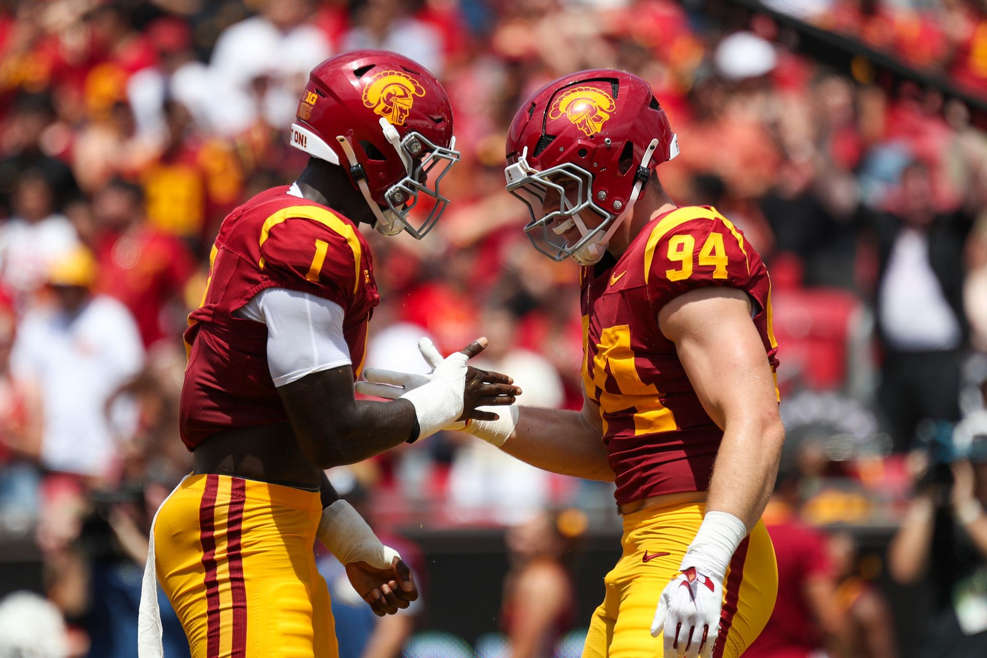 USC's Kameryn Crawford (1) and Luke Waffle (94) celebrate a stop