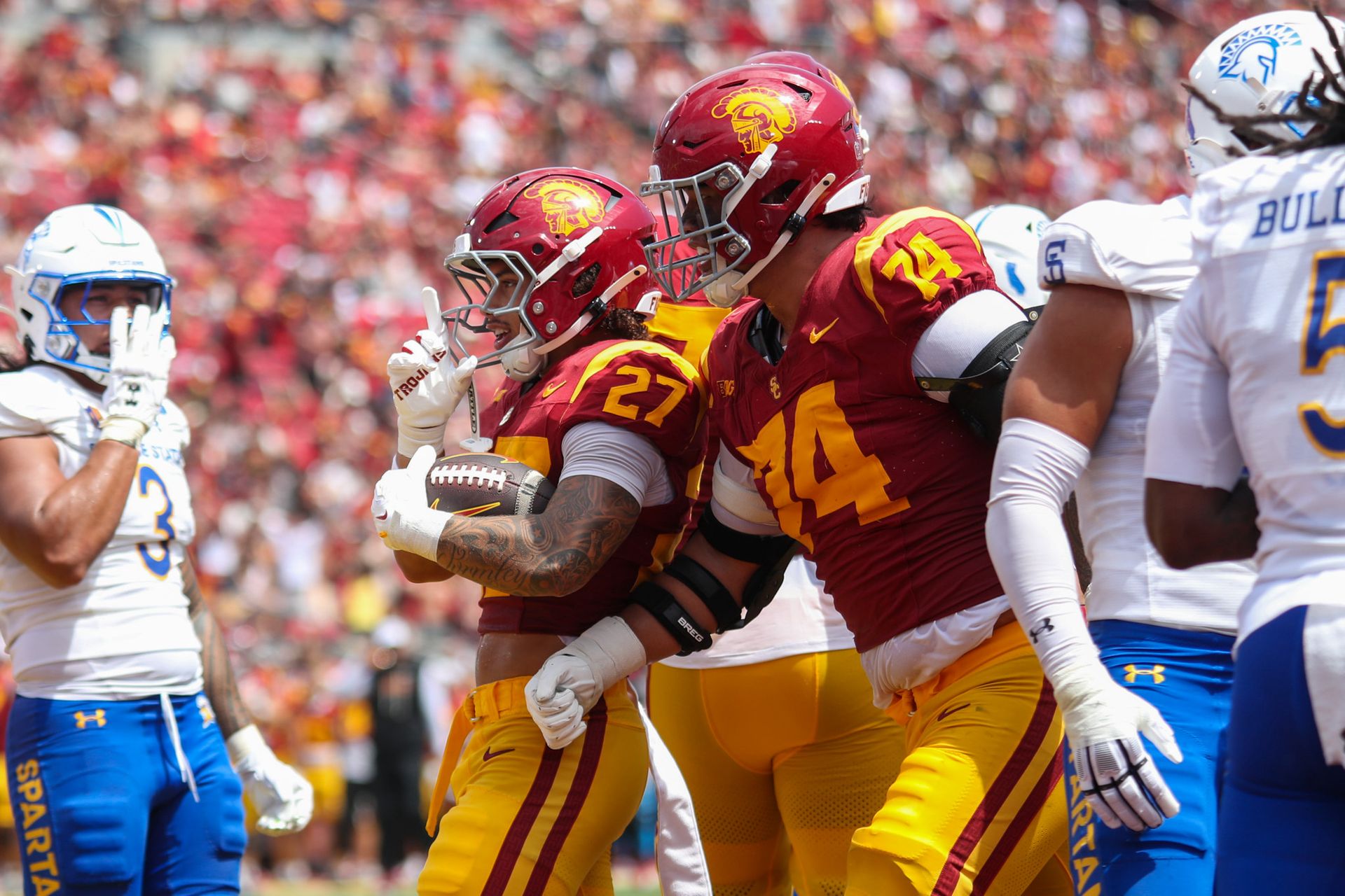 Riley Wormley (27) celebrates a touchdown for USC