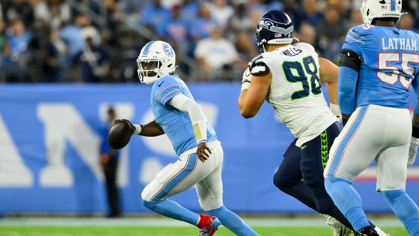 Cam Ward evades Seahawks defense during a tense first half at Nissan Stadium