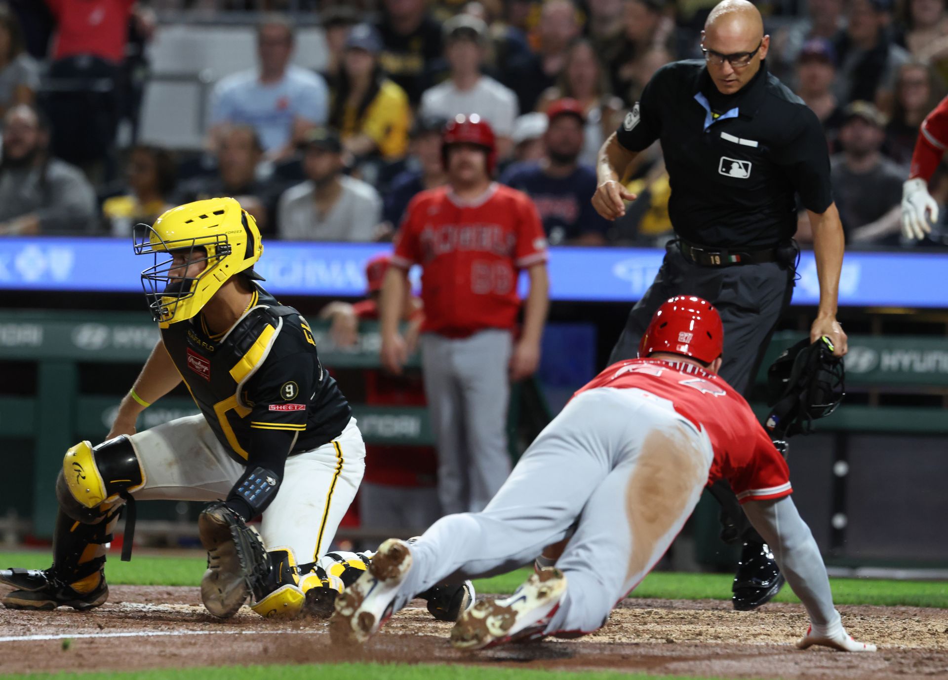 Mike Trout scores against the Pirates in the seventh inning.