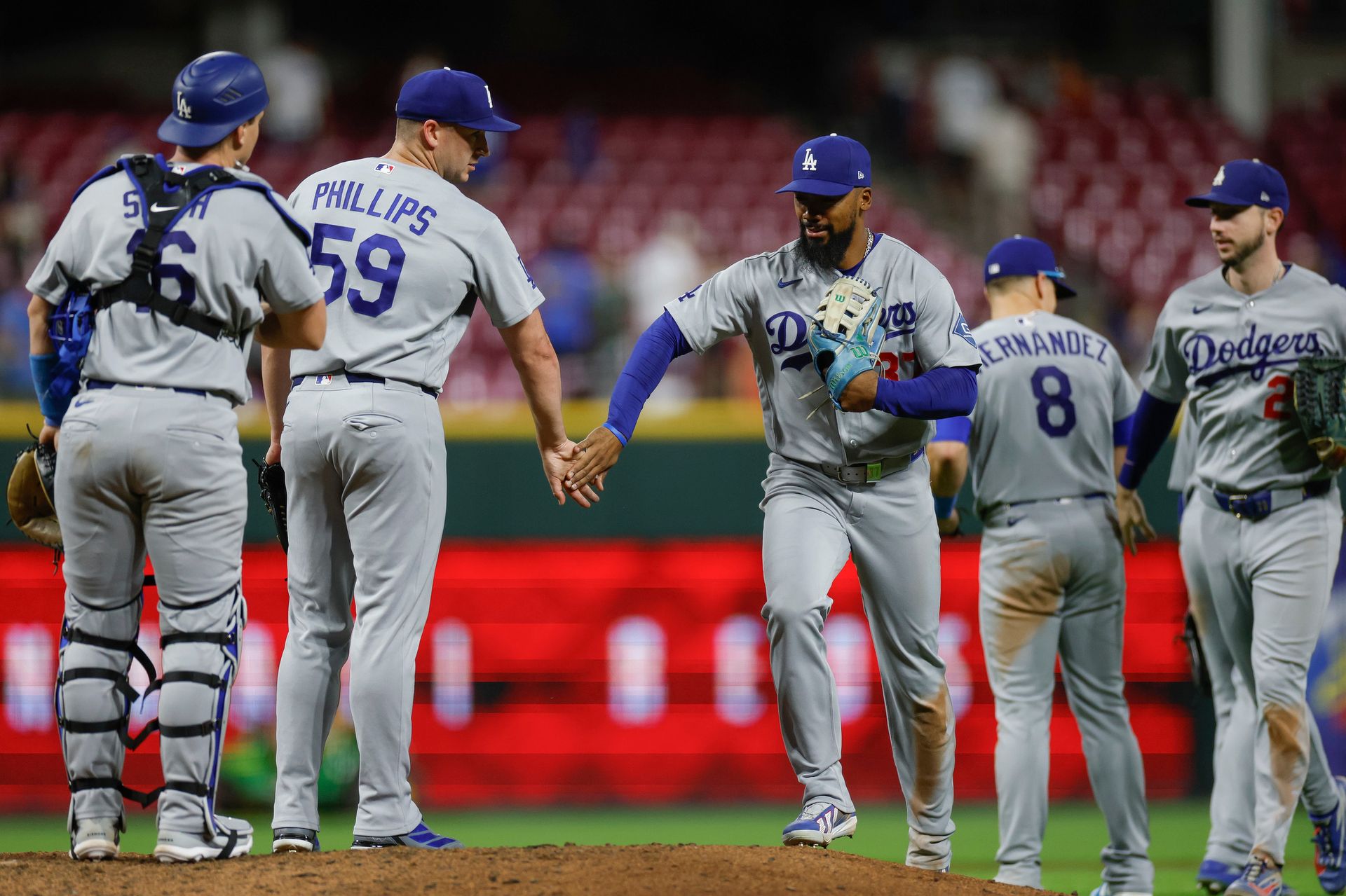 Teoscar Hernandez celebrates with teammates against the Reds, 2026