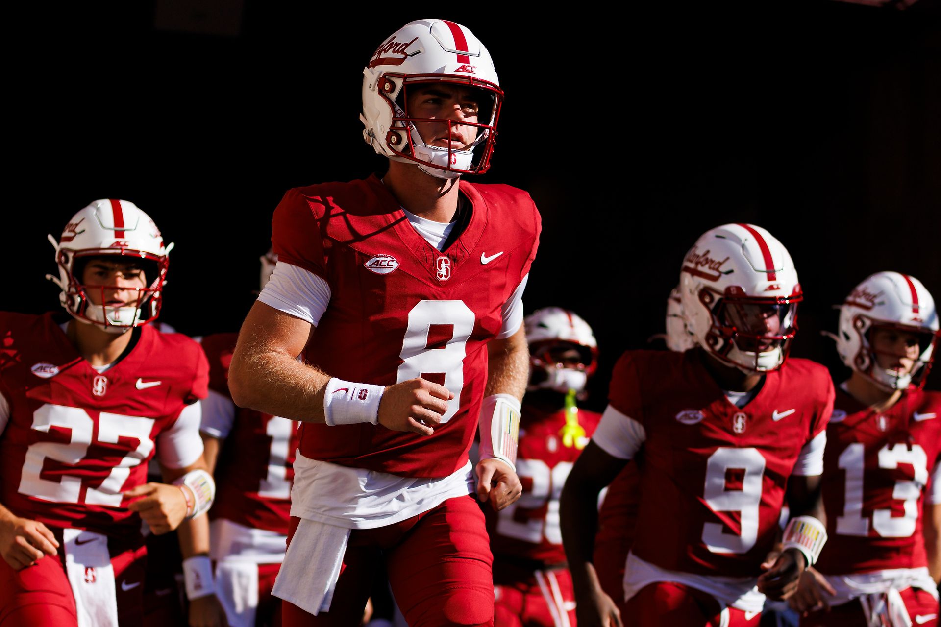 Davis Warren #8 runs onto the field vs. Miami