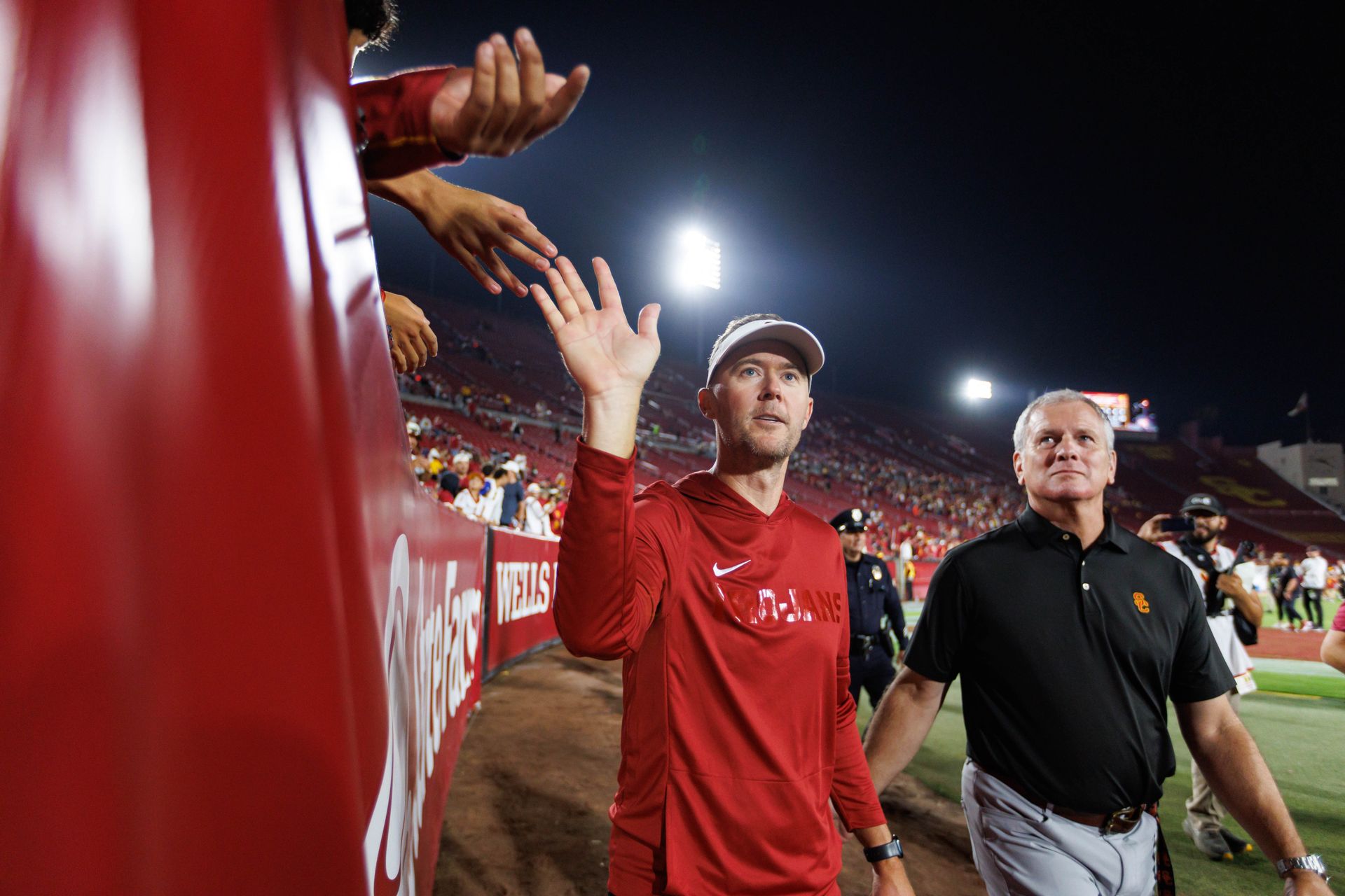 Coach Lincoln Riley interacts with fans post-game