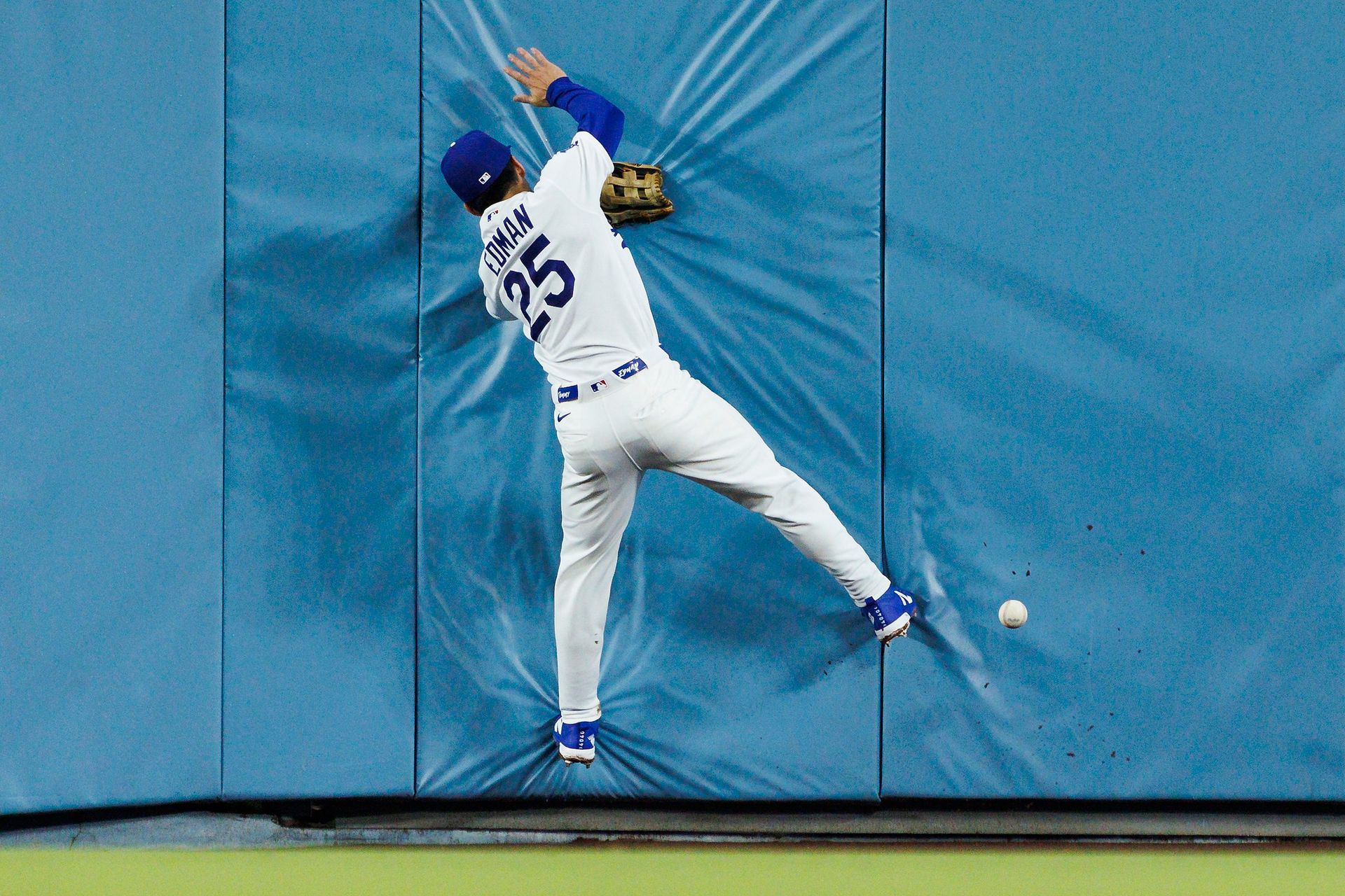 Tommy Edman crashes into the wall during the game