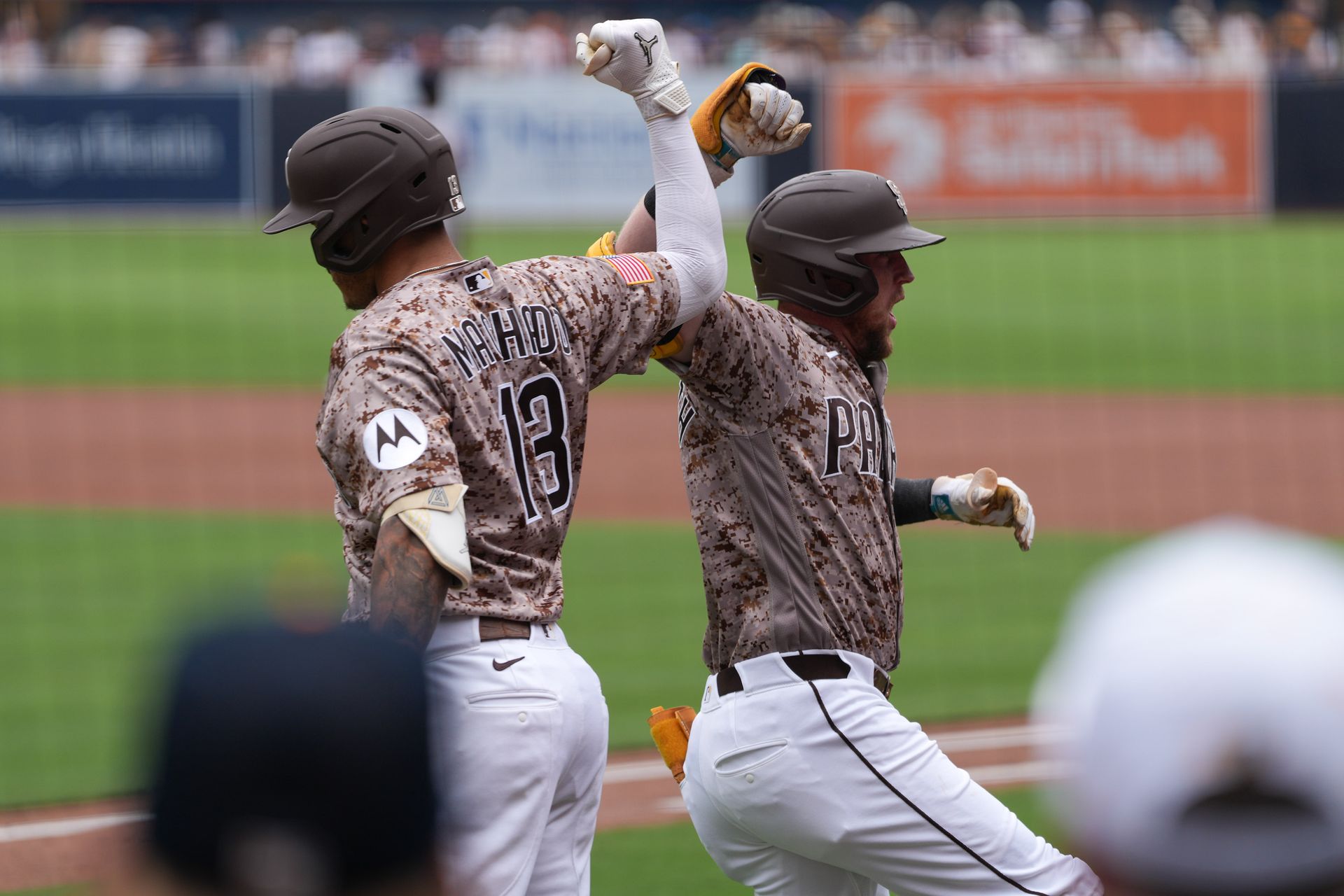 Cronenworth and Machado celebrate home run at Petco Park
