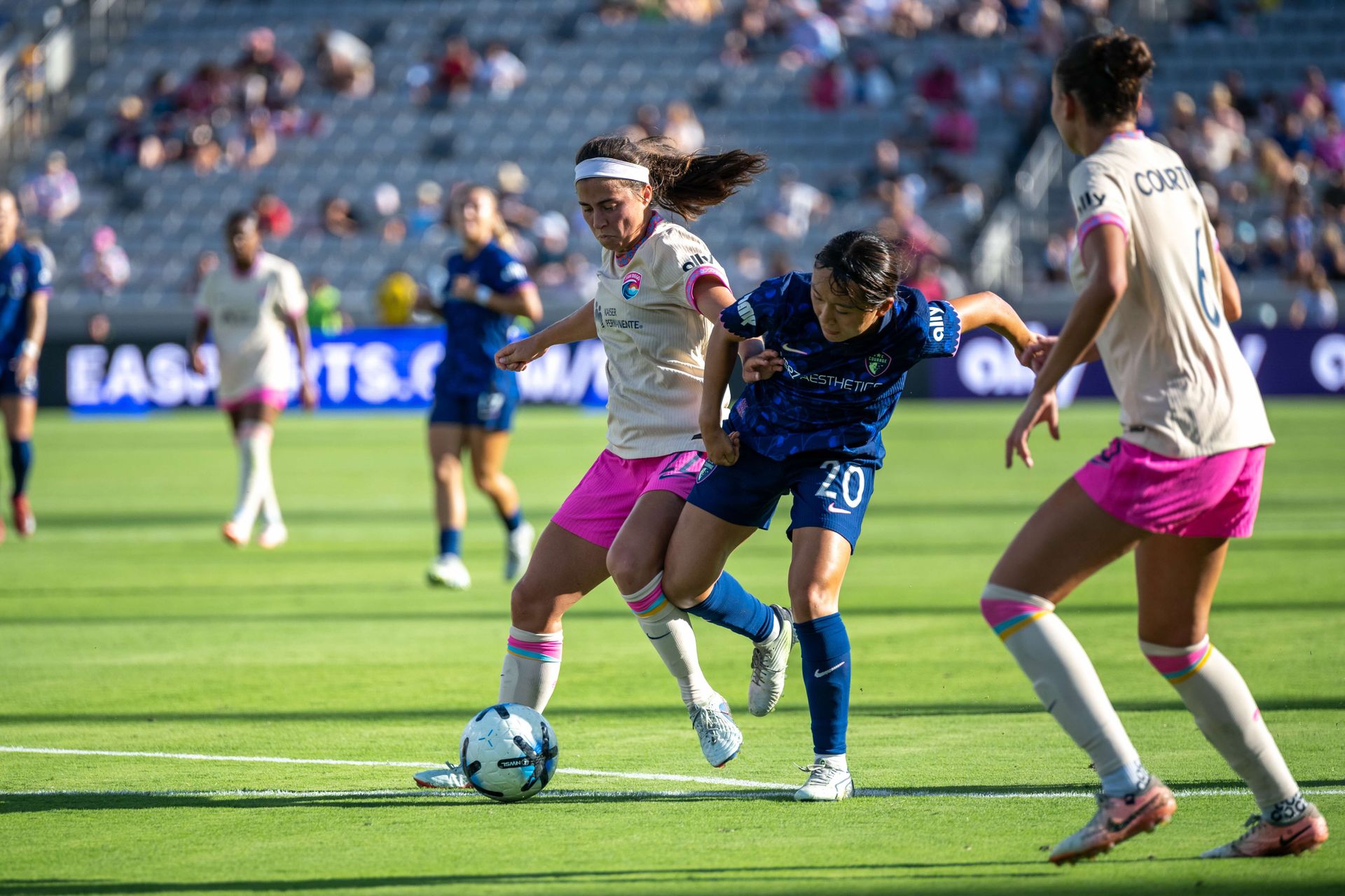 Lia Godfrey competes for the ball with Shinomi Koyama