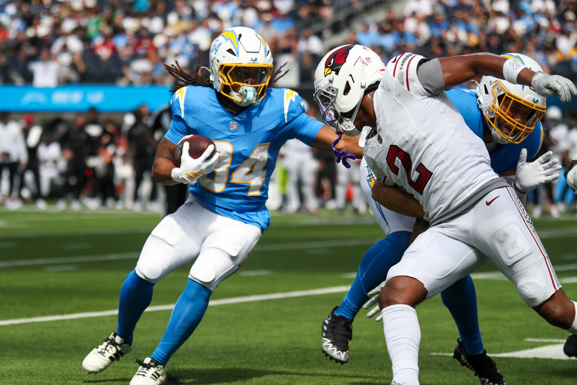 Keaton Mitchell carries the ball for the Chargers