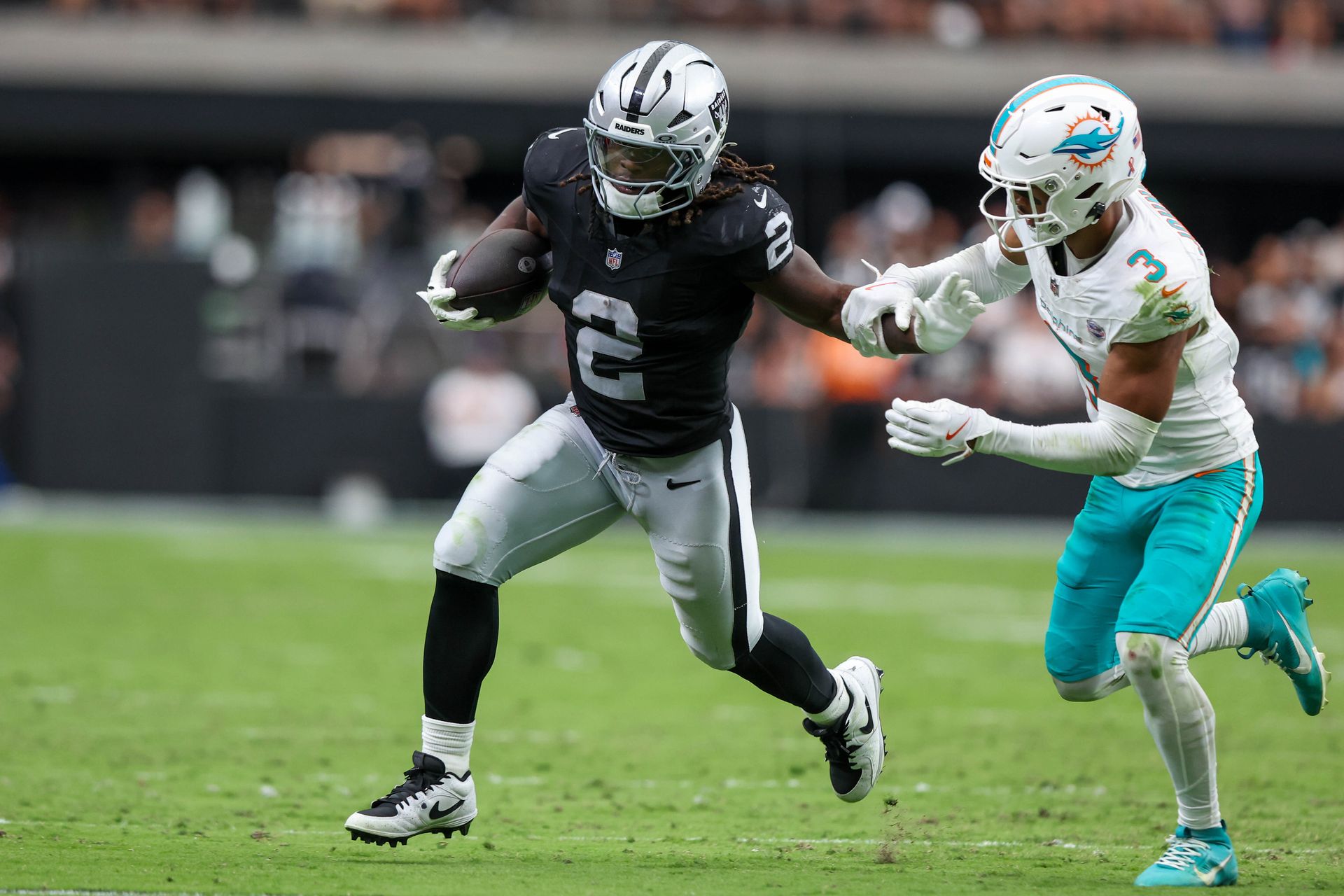 Ashton Jeanty in action running the ball against the Dolphins