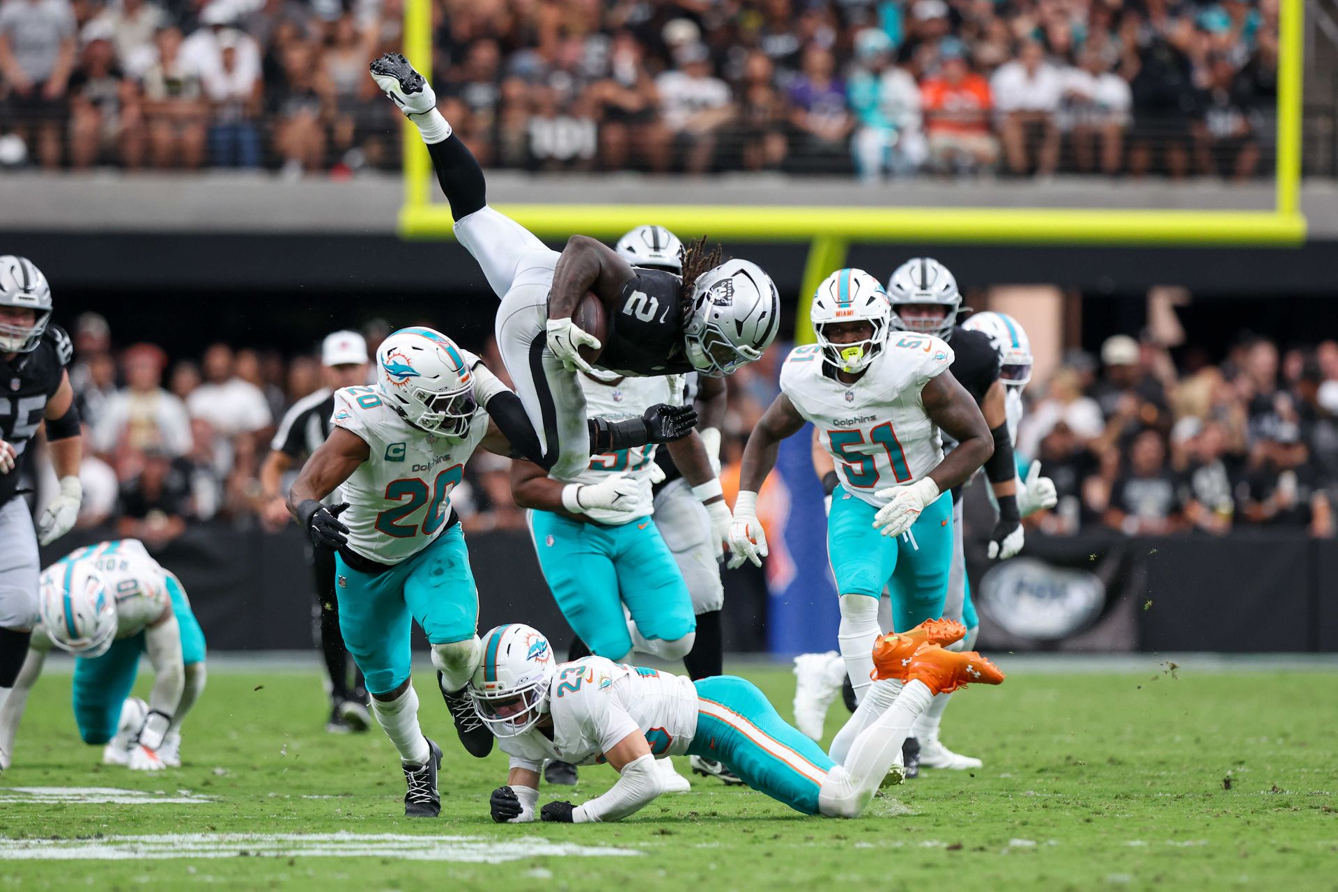 Ashton Jeanty runs the ball in a game against the Dolphins