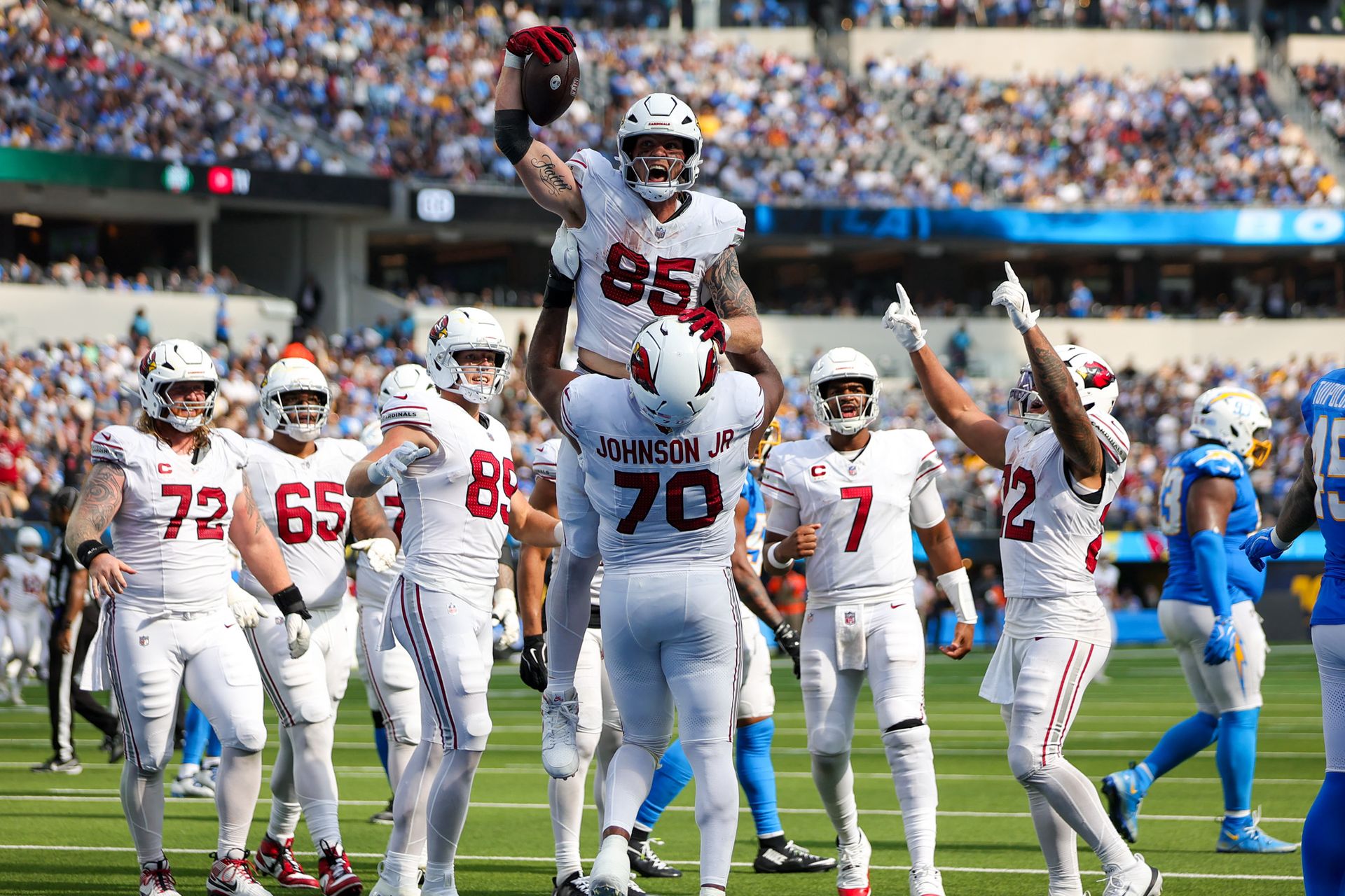Trey McBride celebrates a touchdown with Cardinals teammates
