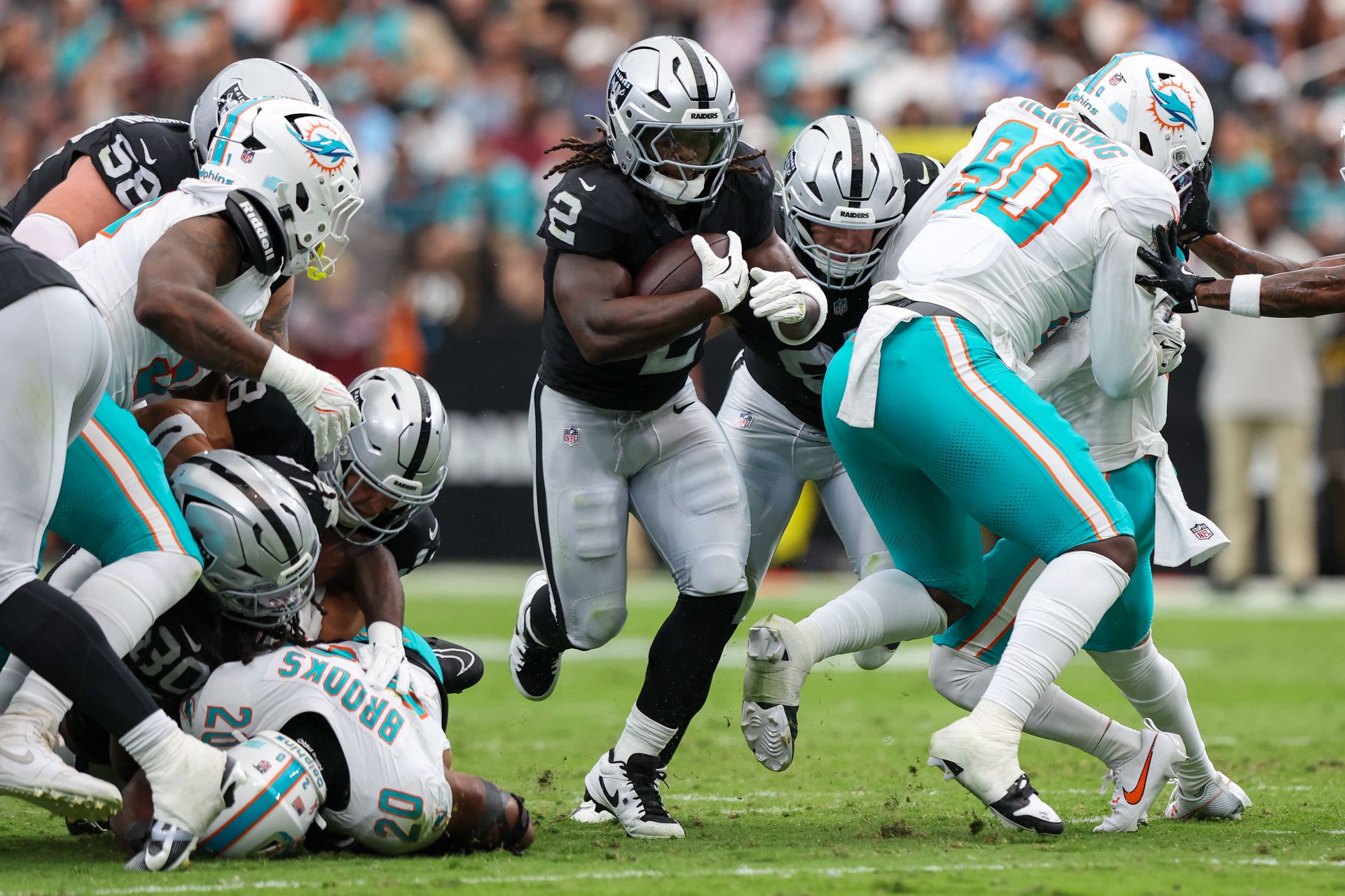 Ashton Jeanty runs the ball in a matchup against the Dolphins