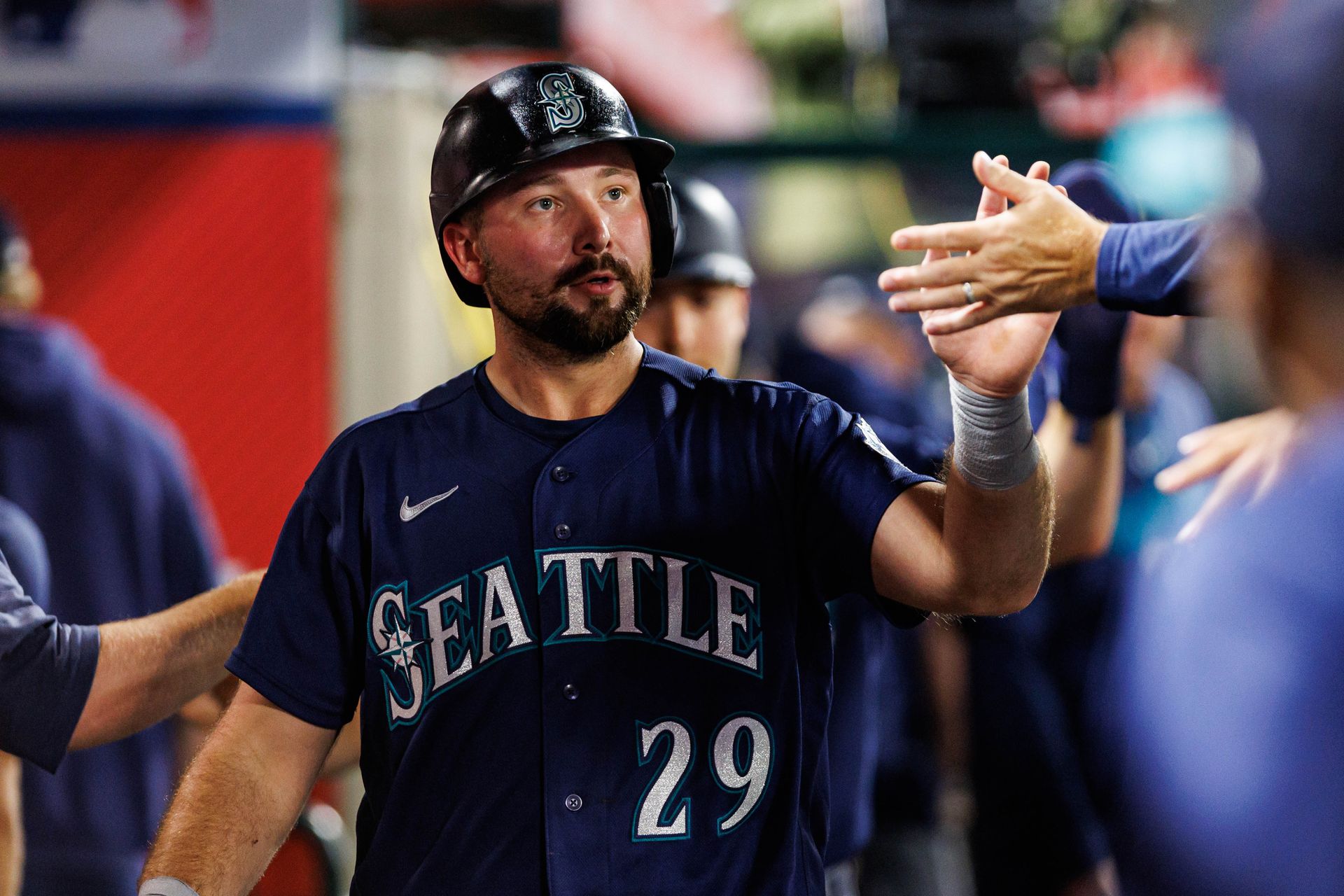 Cal Raleigh #29 celebrates a run in the game against the Angels.