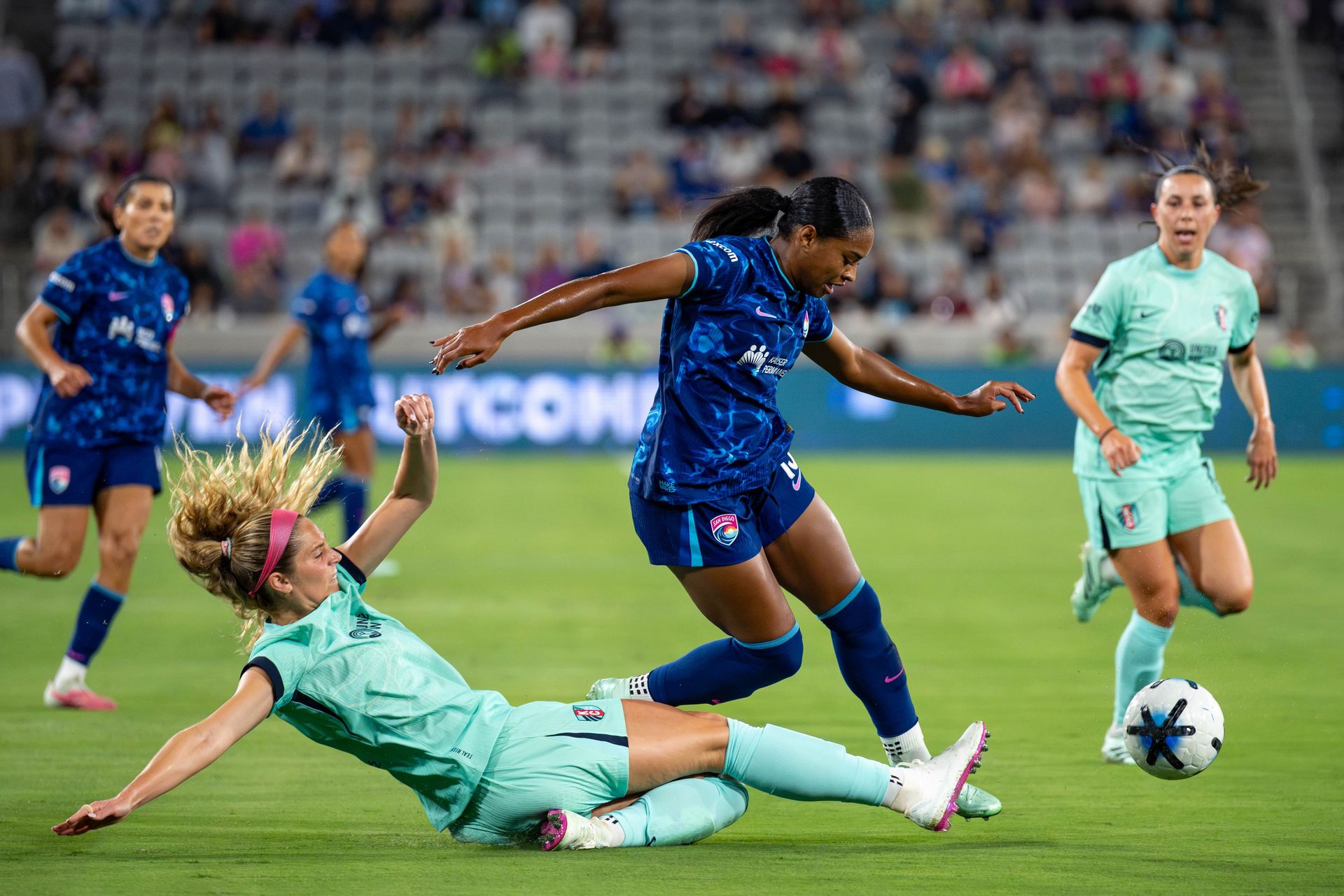 Trinity Byars tackled by KC Current's Kayla Sharples in NWSL match.