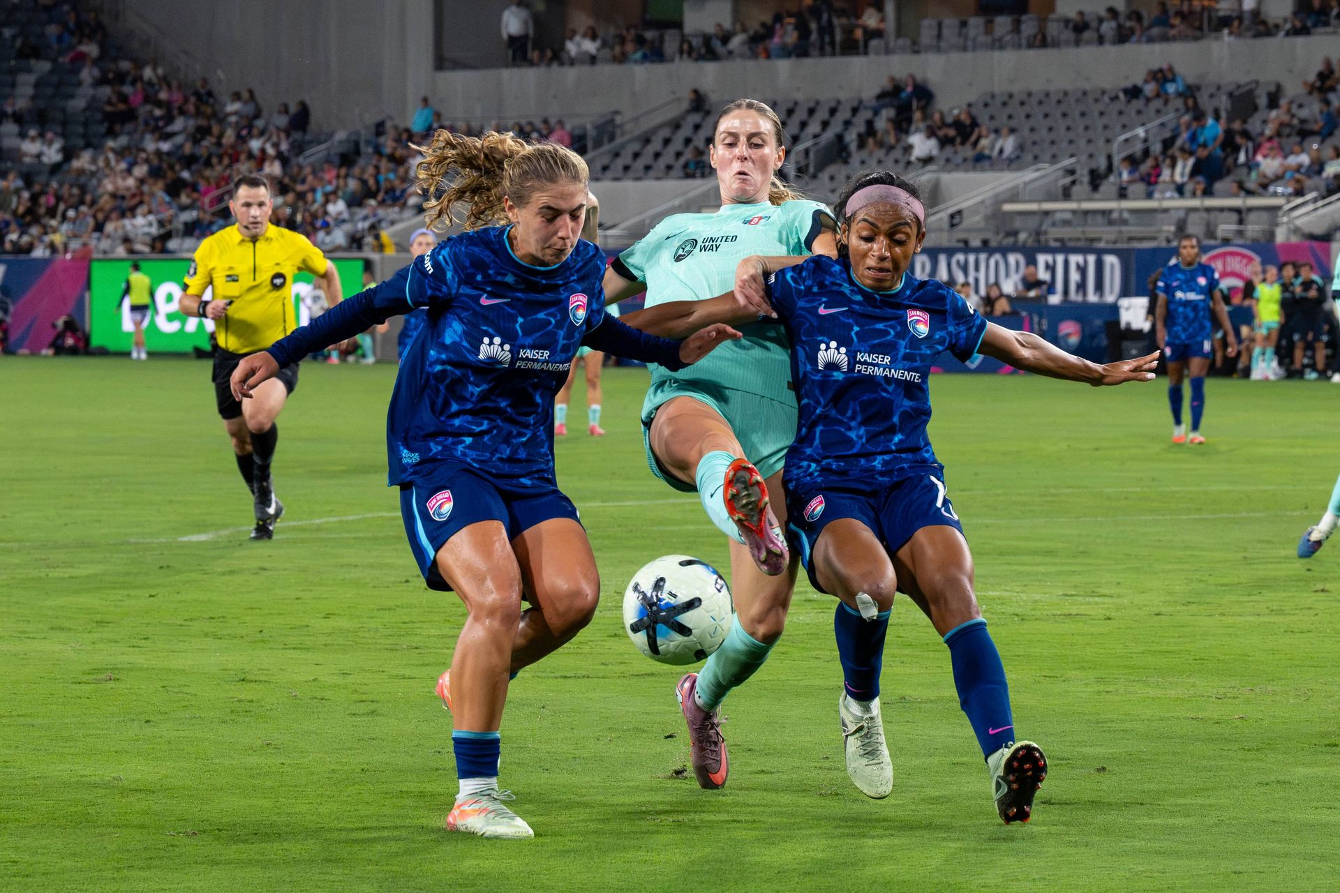 Kimmi Ascanio and Perle Morroni work together to maintain possession.