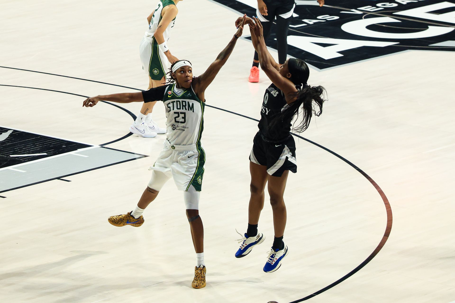 Jackie Young shoots a three-pointer guarded by Jordan Horston