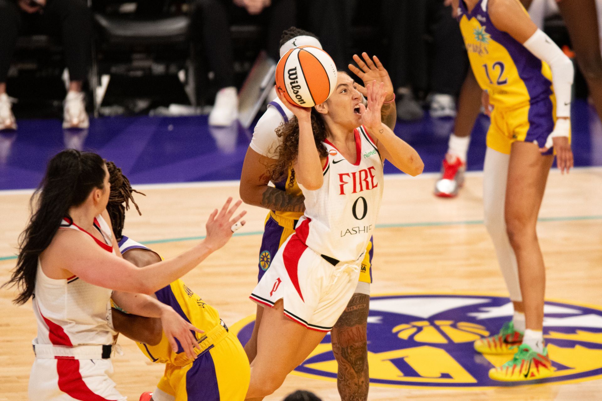 Carla Leite drives to the rim in a WNBA match.