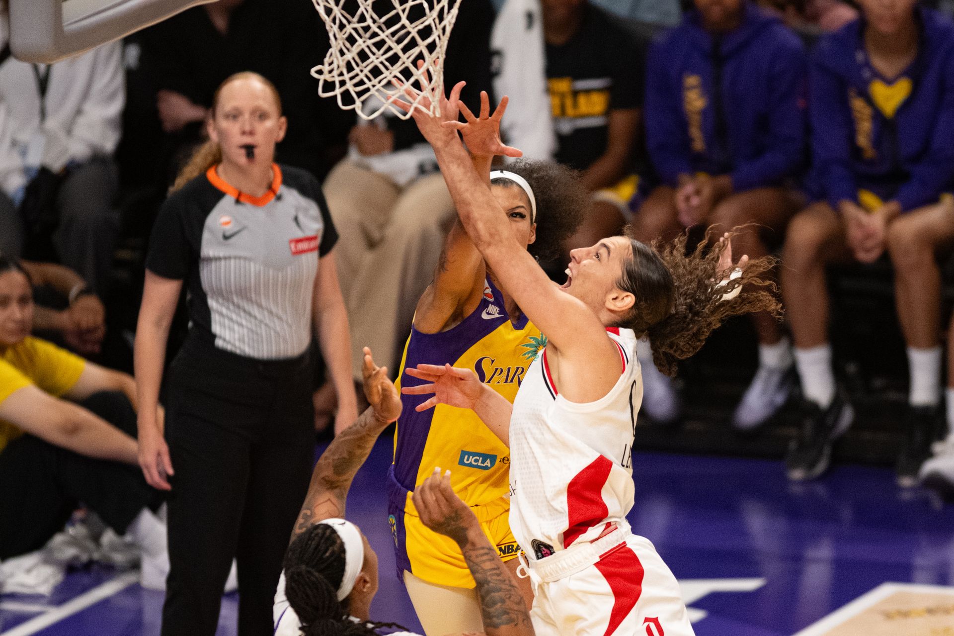 Carla Leite drives to the rim and gets fouled.