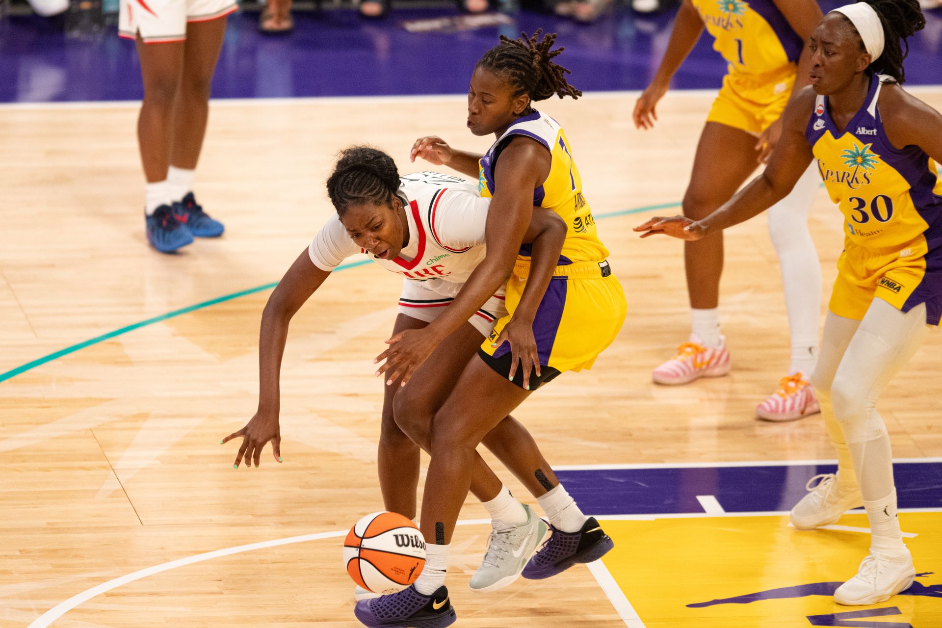 Ariel Atkins defends the paint in WNBA game.