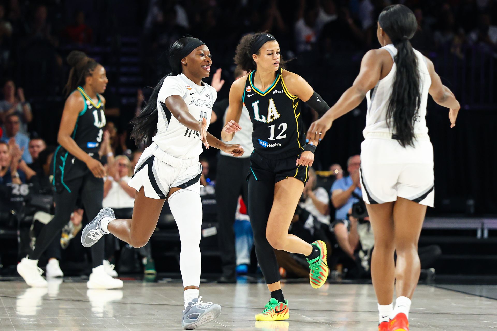 Dana Evans celebrates a three-pointer against the Sparks