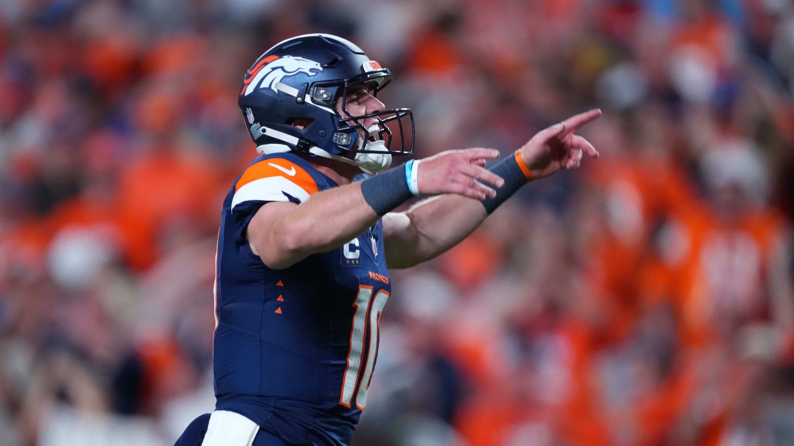 Bo Nix celebrates a touchdown with Broncos teammates.