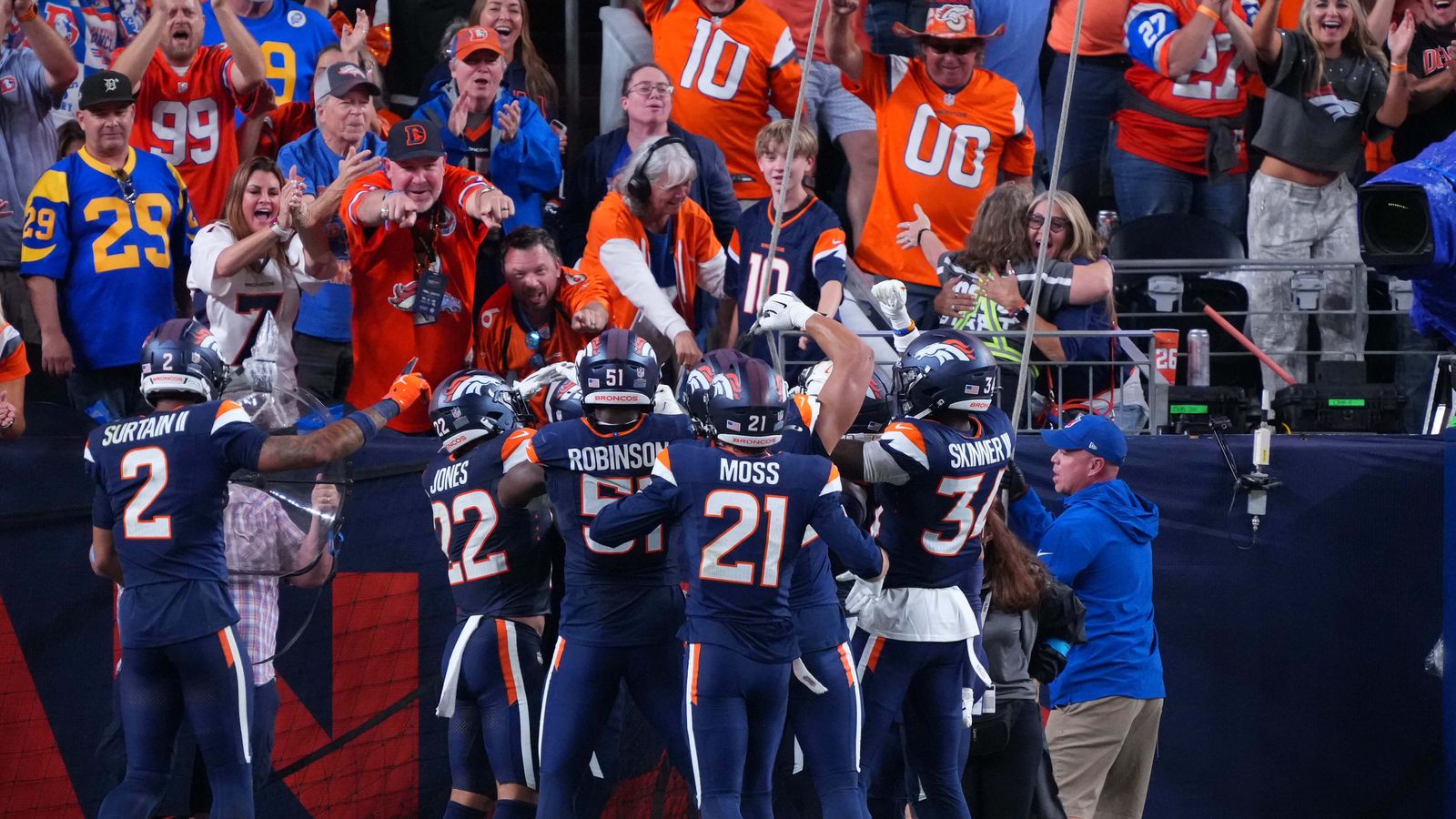 Hufanga celebrates a pick six with Denver fans.