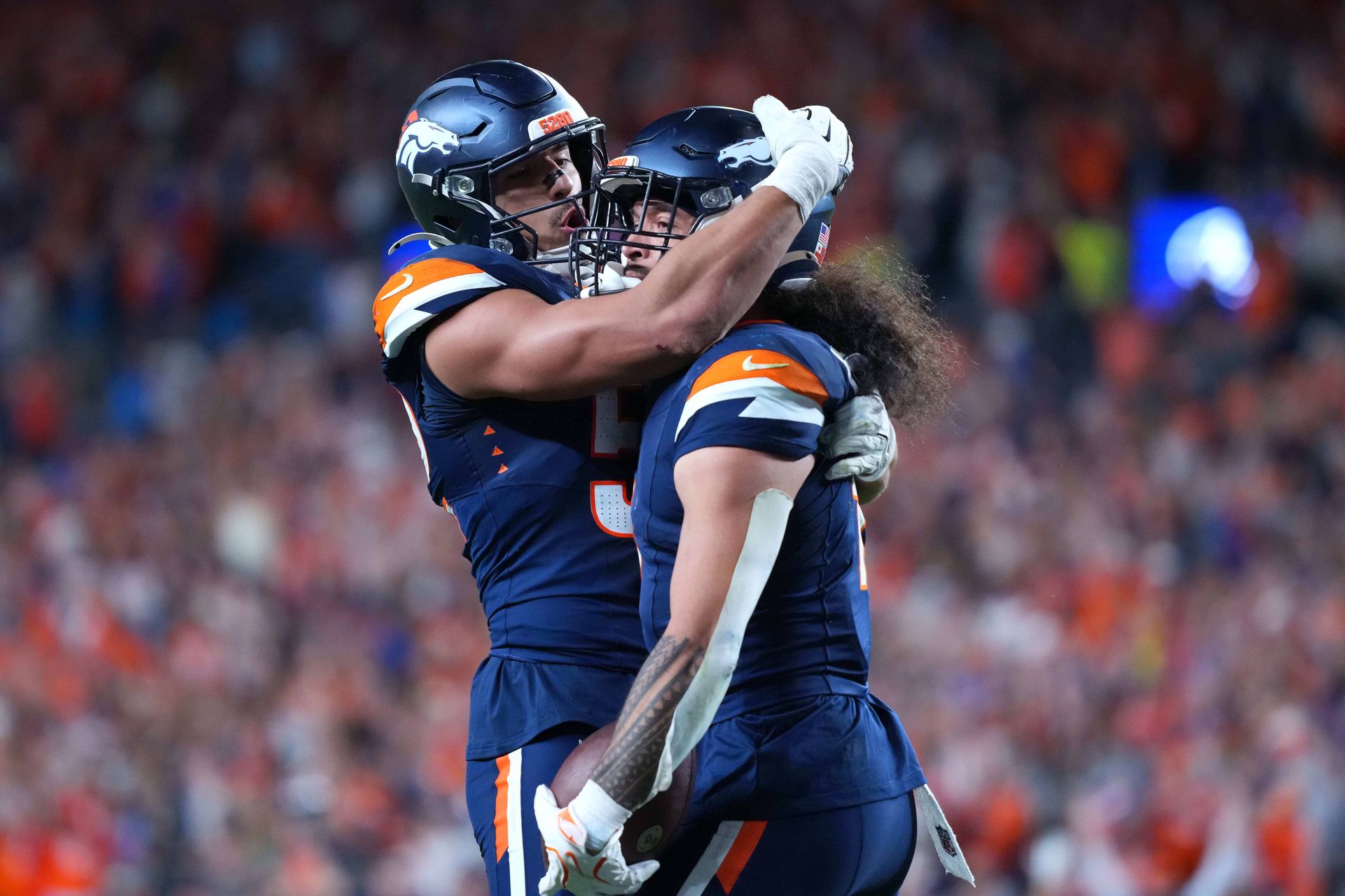 Hufanga celebrates with fans and teammates after an intercept