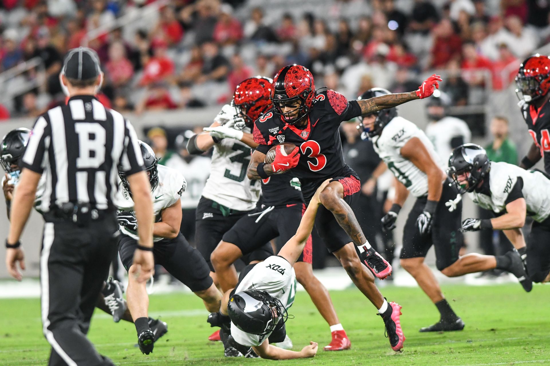 Nathan Acevedo hurdles a defender on a kickoff return