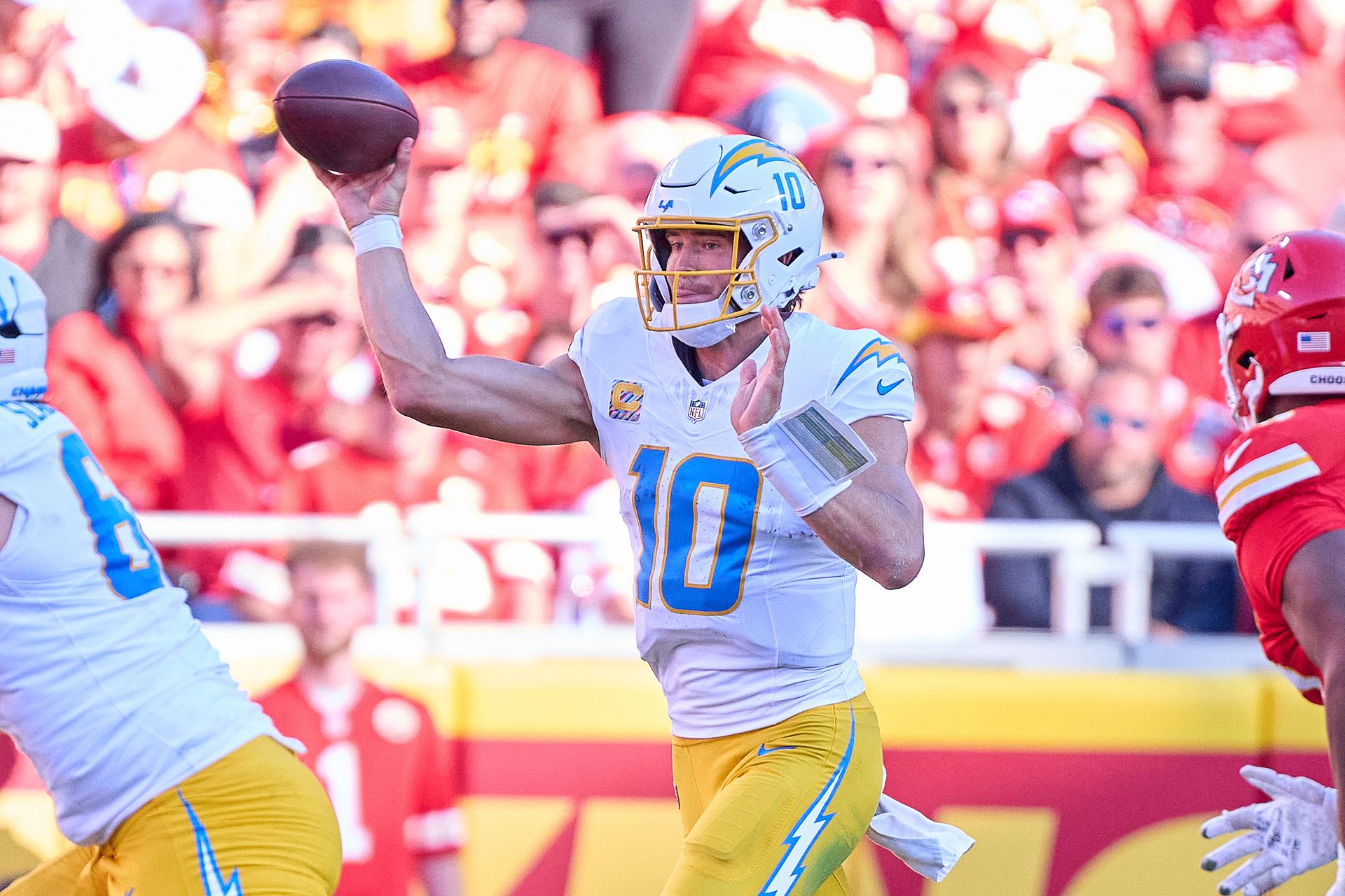 Justin Herbert throws against the Chiefs at Arrowhead Stadium