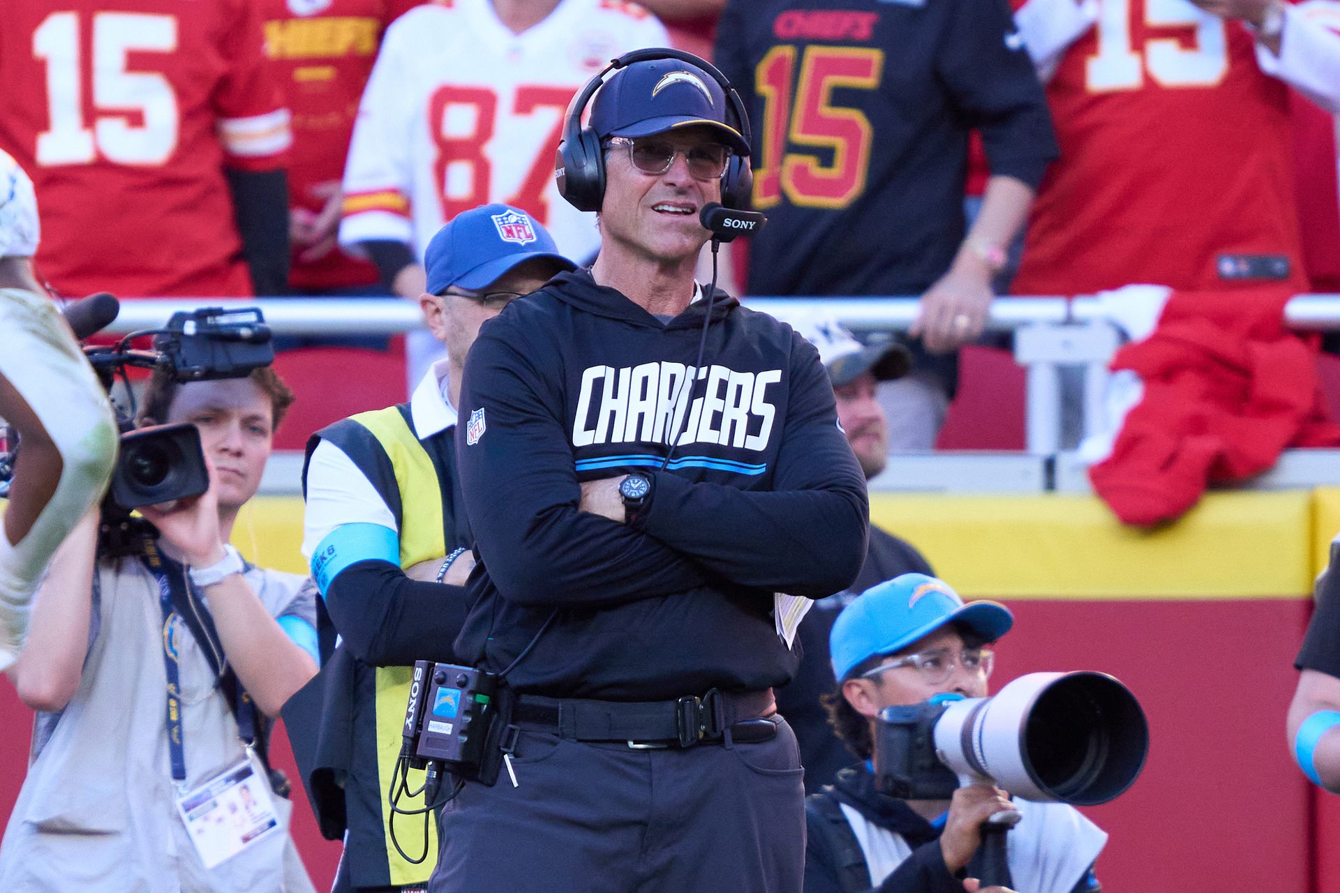 Chargers coach Jim Harbaugh surveys the field in Kansas City