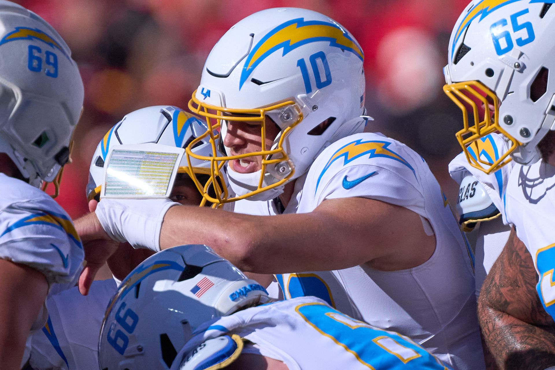 Justin Herbert leads the Chargers huddle at Arrowhead Stadium