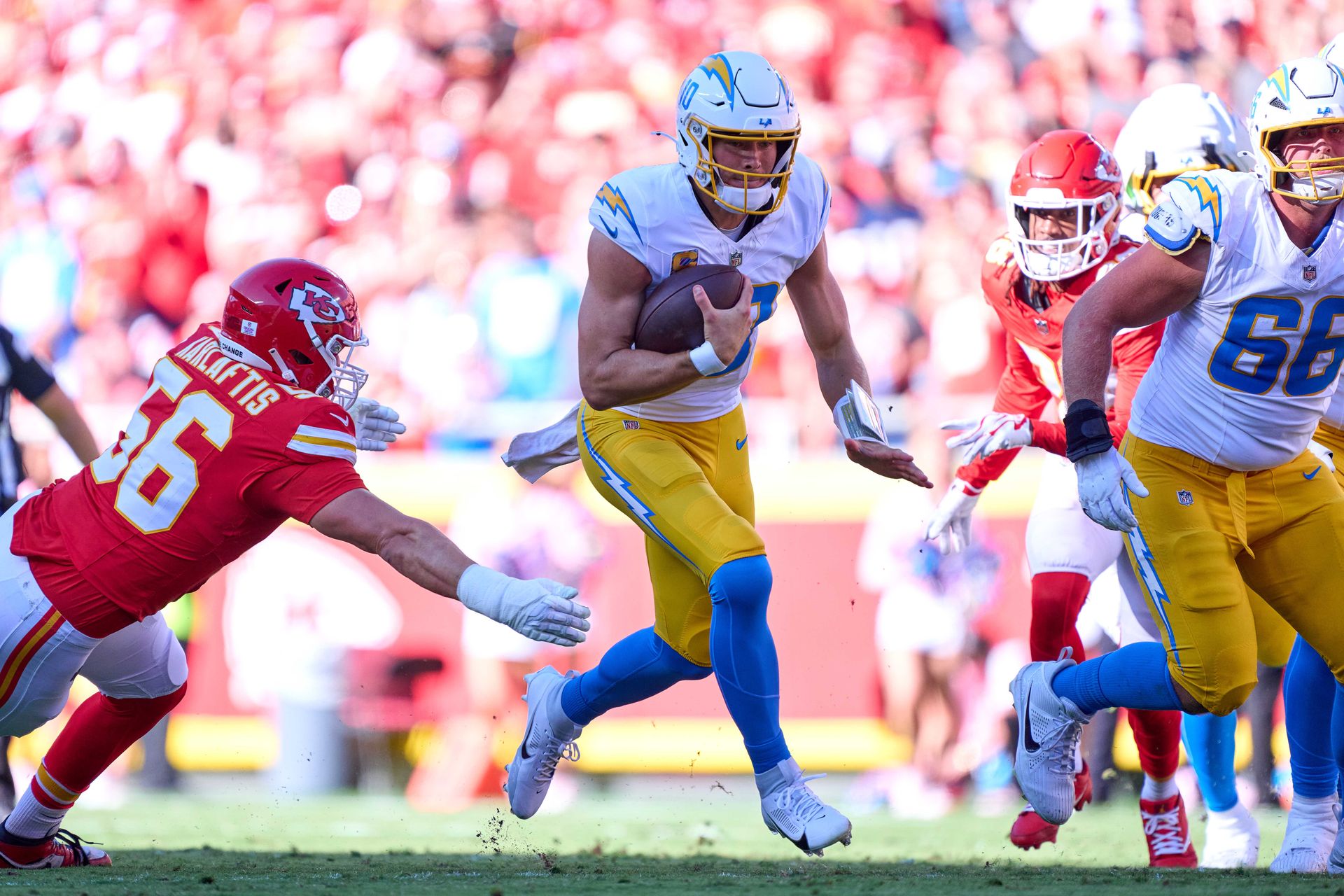 Justin Herbert runs with the ball against the Kansas City Chiefs