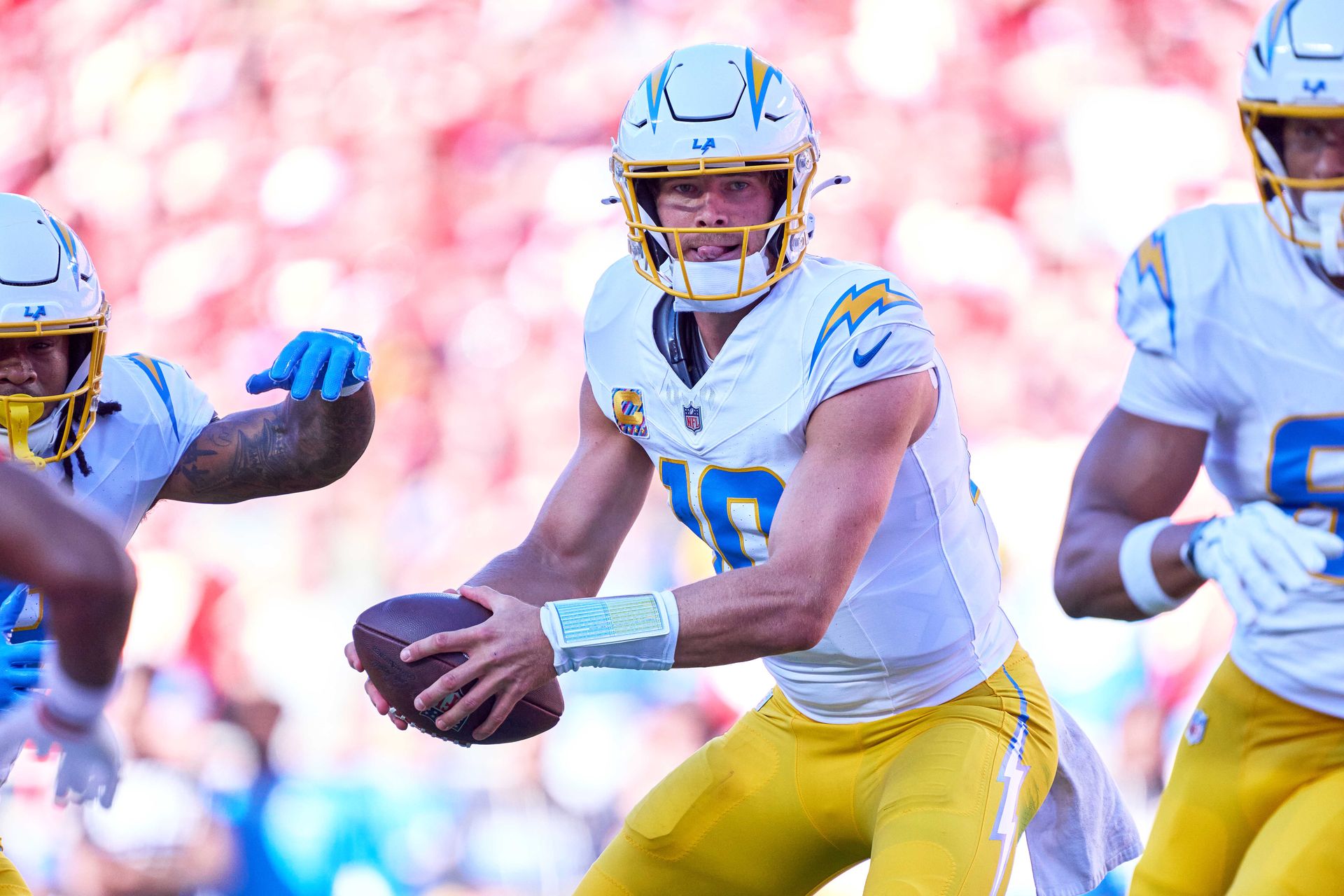 Justin Herbert controls the ball against the Kansas City Chiefs