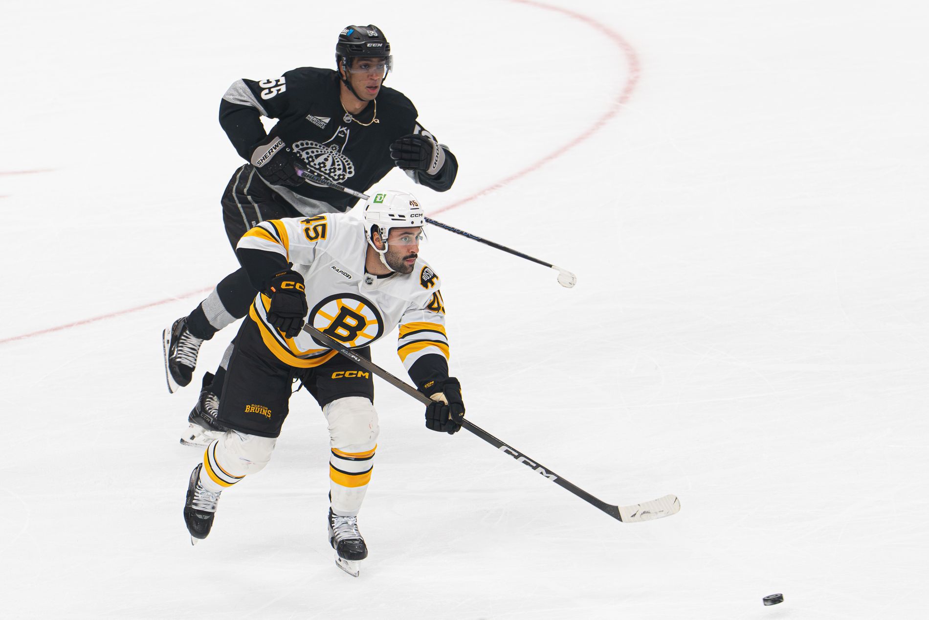 Quinton Byfield defends against the Boston Bruins