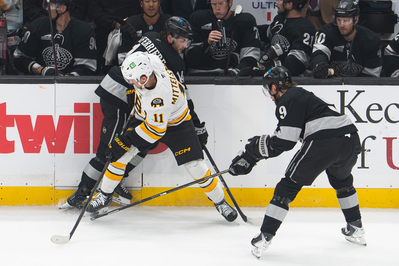 Kings defenders converge on the puck against Boston