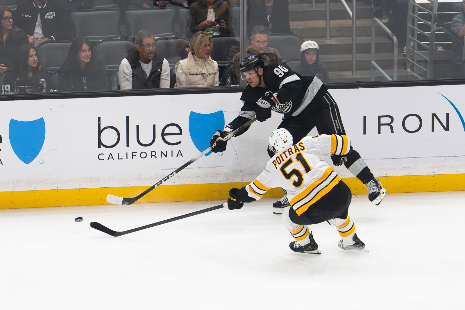 Corey Perry passes around a Bruins defender