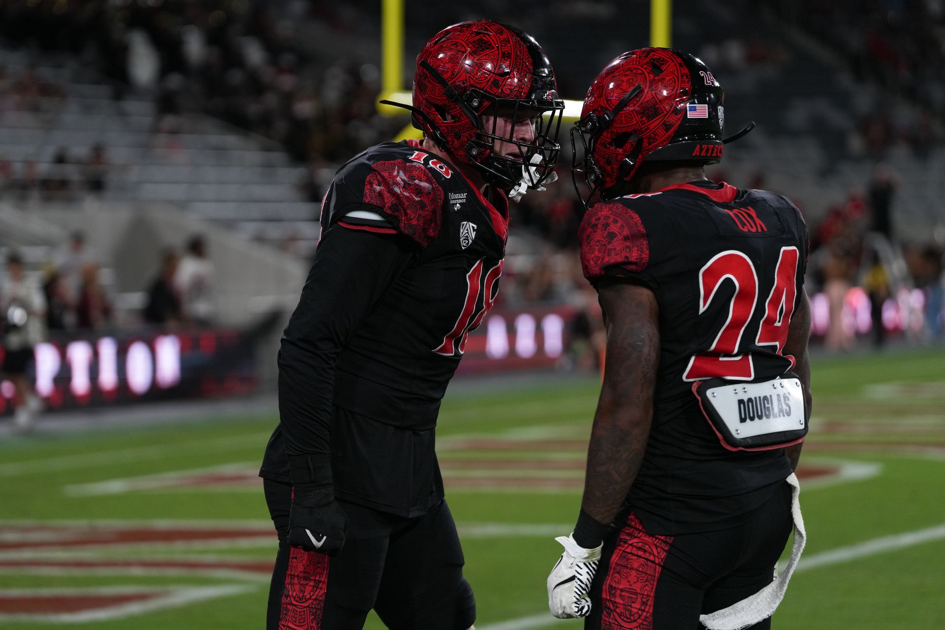 Kai Wallin (18) and Josiah Cox (24) celebrate an interception, NCAA game